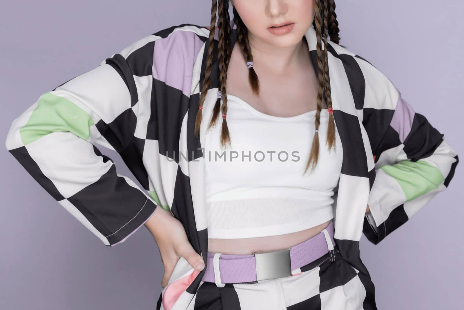 Closeup beautiful young girl with perfect skin, cosmetic and long braid posing with trendy fashion outfit in the studio with isolated background. charming young teenage with beauty gesture.