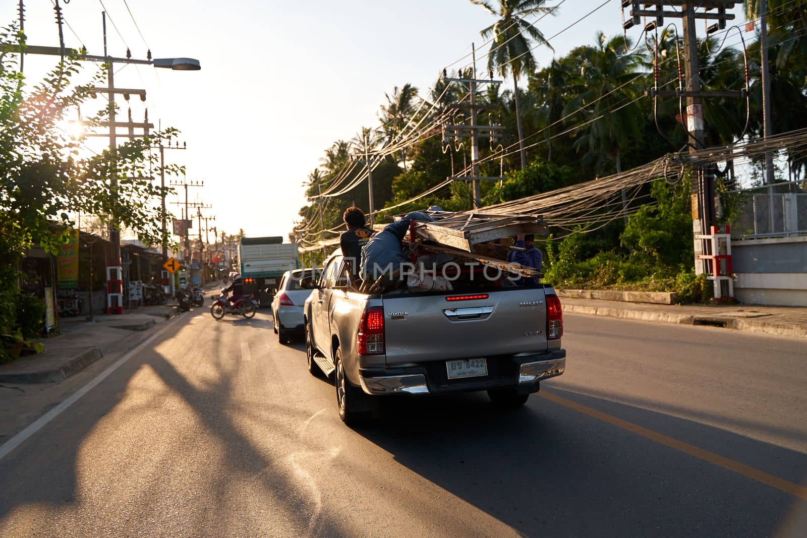 Atmospheric photo traffic on the street in Thailand during sunset. Koh Samui, Thailand - 09.15.2022