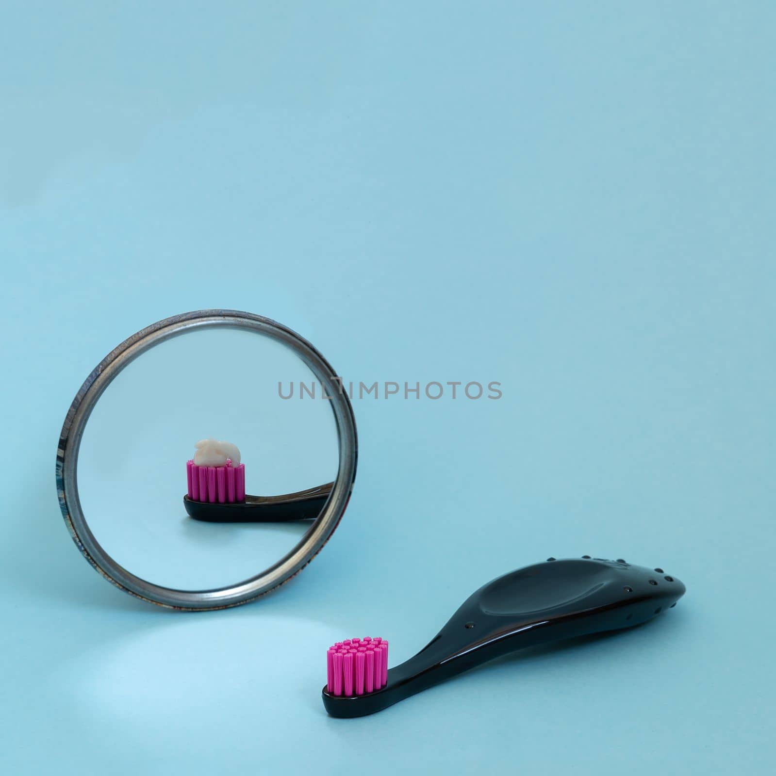 Kids toothbrush with toothpaste mirorr reflection. International day of dentist. Creative concept of daily morning routine. Copy space, square format for instagram. by Ri6ka