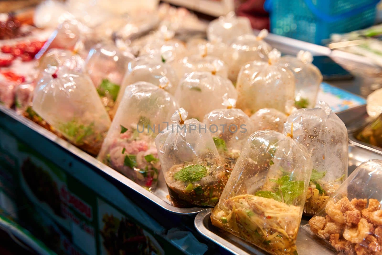 Bags of soup and liquid food at a street food market in Thailand.