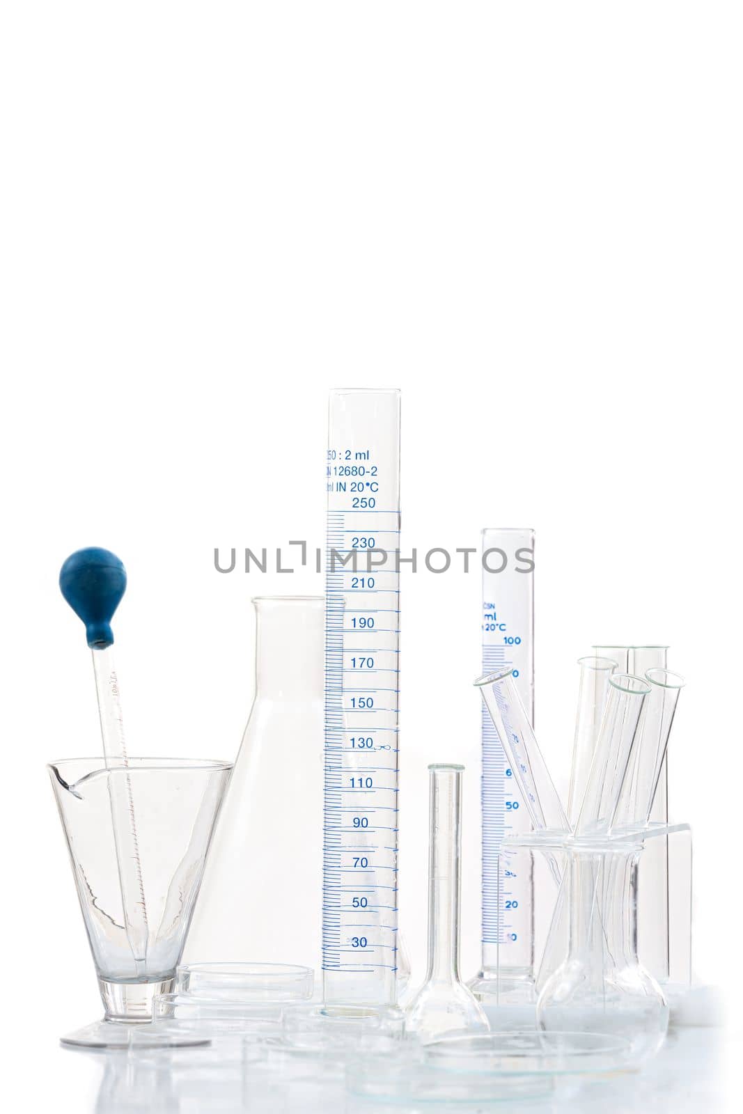 Set of laboratory glassware with blue liquid on white background. by JPC-PROD