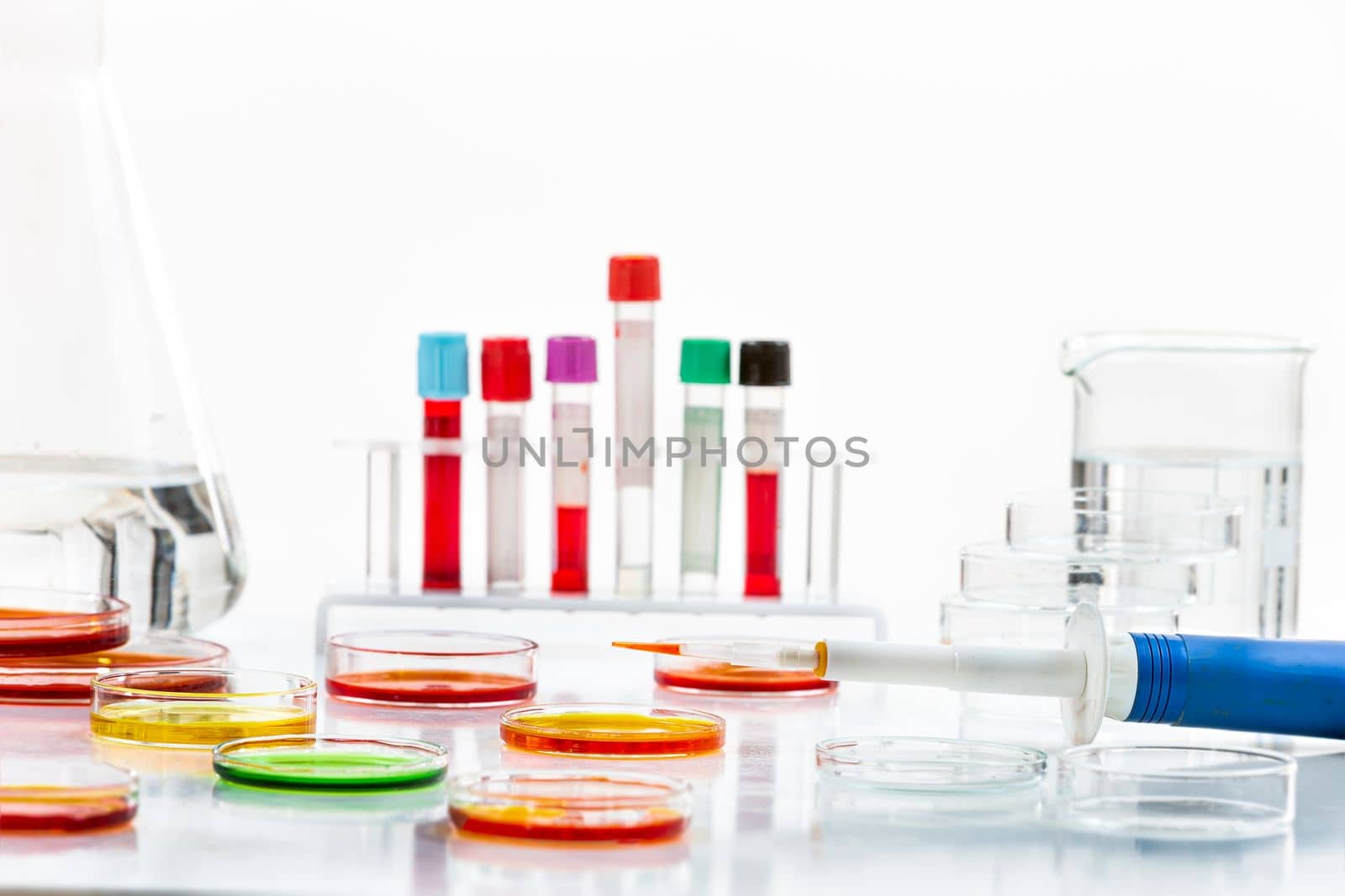 Research in laboratory analysis - Test tubes and Petri dishes with blood samples and urine sample for analysis on table in laboratory on white by JPC-PROD