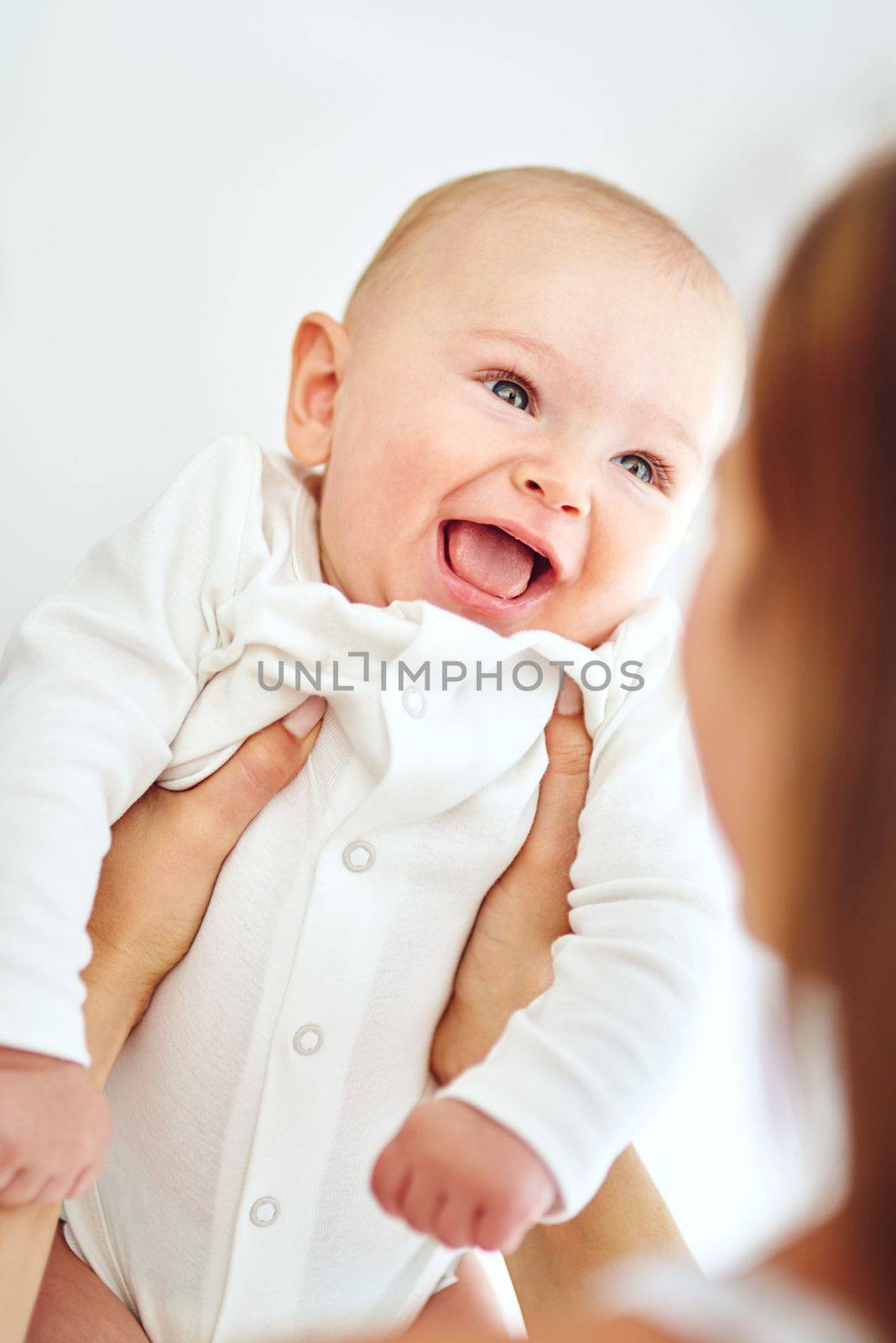 Tiny blessings make life a joy. a loving mother carrying her baby boy at home