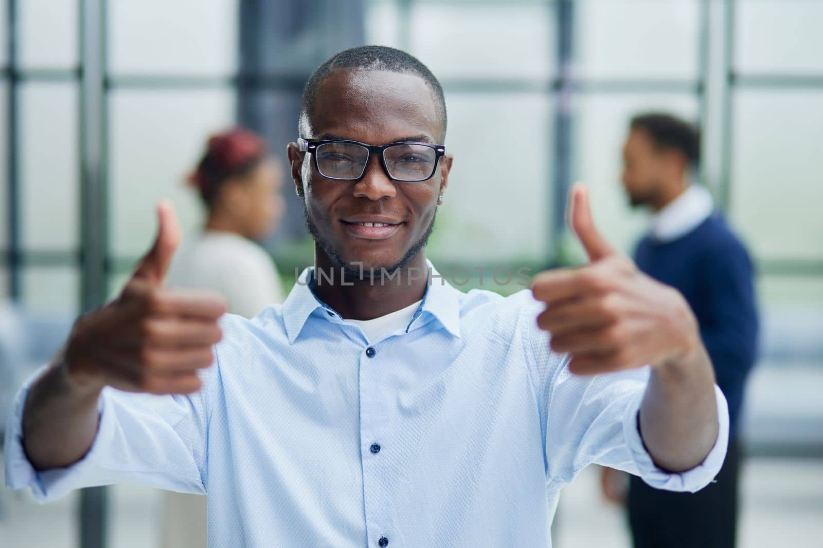 Portrait of happy afroamerican handsome man and showing thumb up gesture