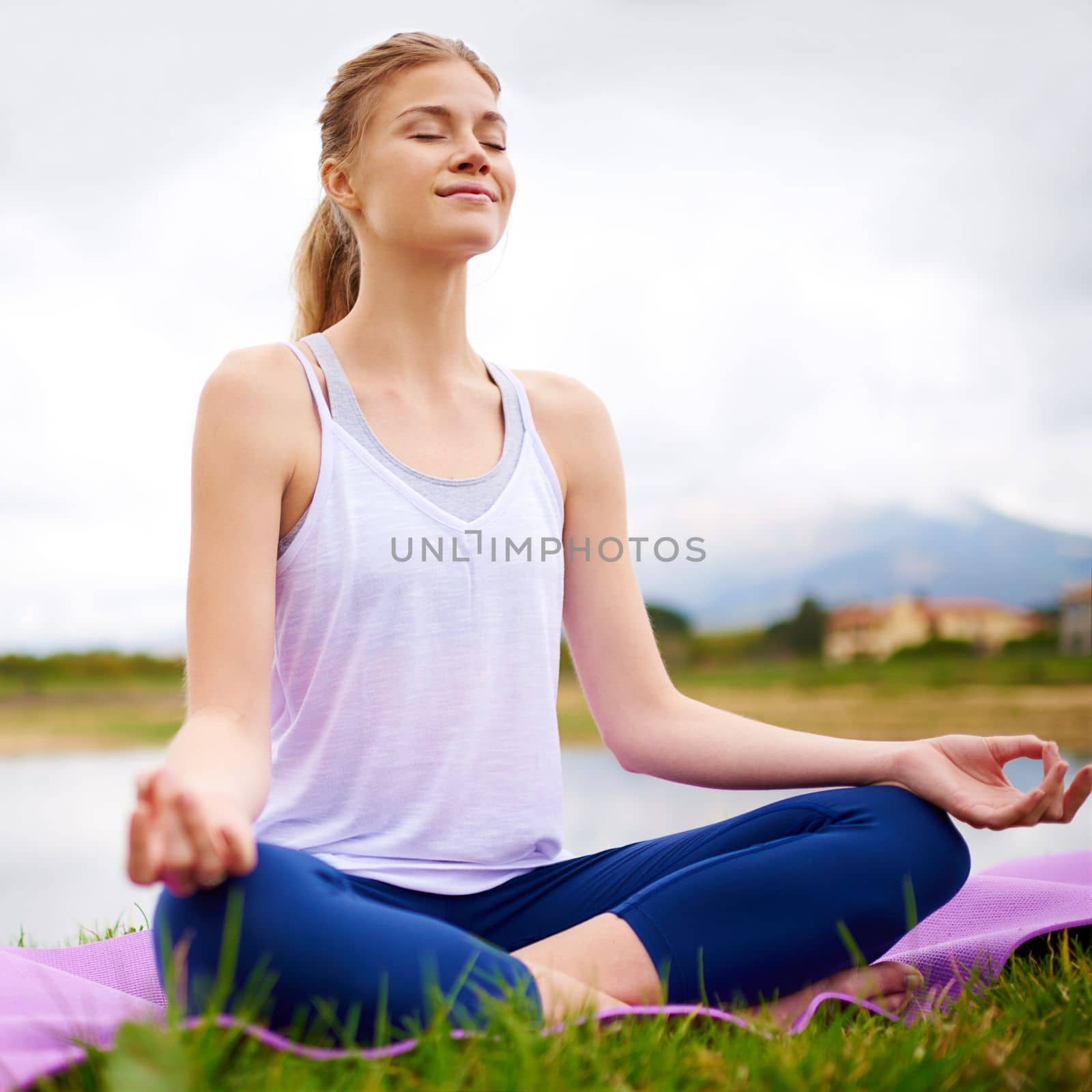 When you own your breath, no one can steal your peace. a young woman doing yoga outdoors