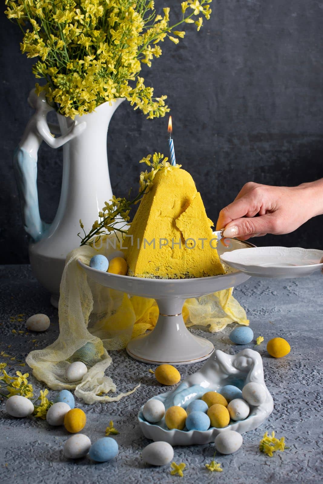 Traditional Easter Orthodox curd cake with yellow flowers on a grey table, High quality photo