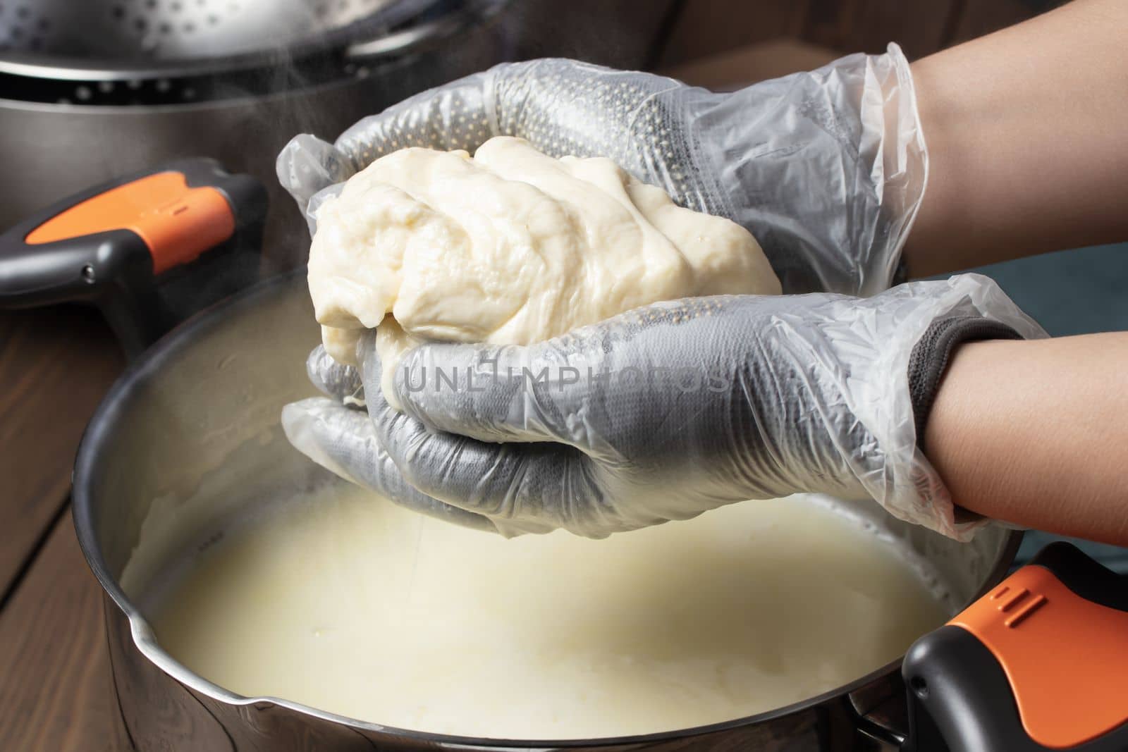 Making mozzarella cheese. Reheating the cheese curd before pulling by galsand