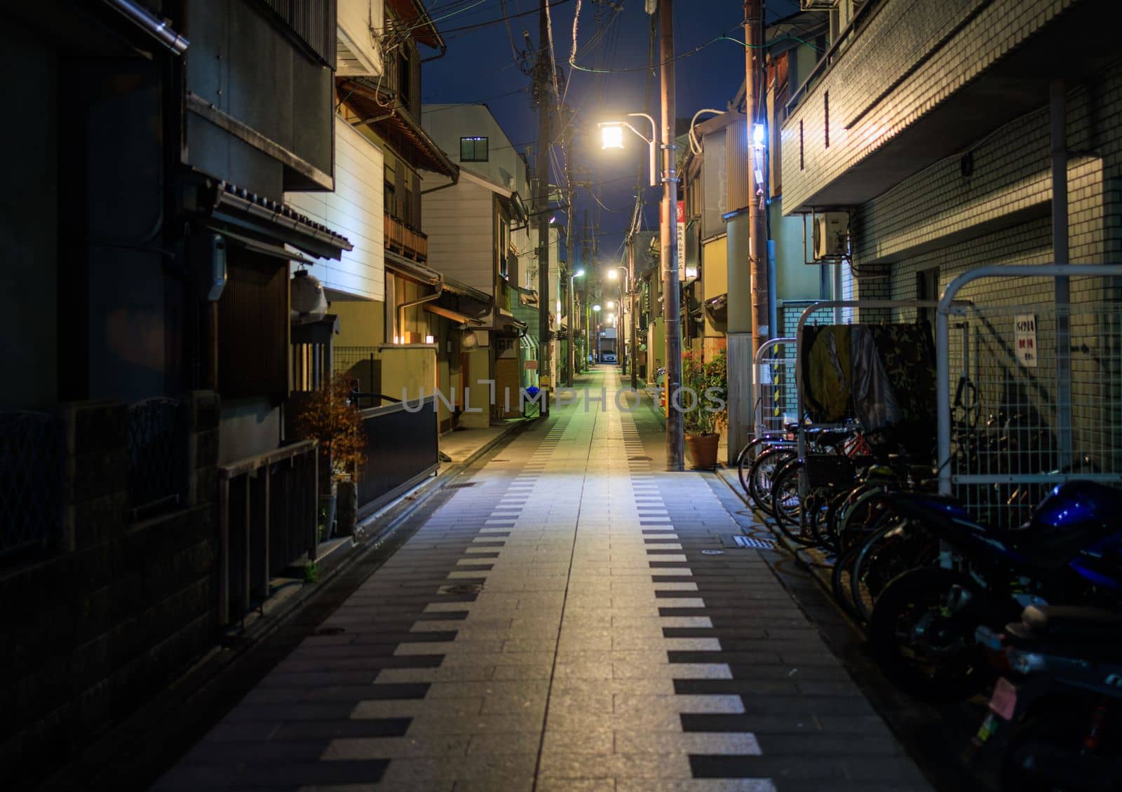 Quiet street in residential Kyoto neighborhood at night by Osaze