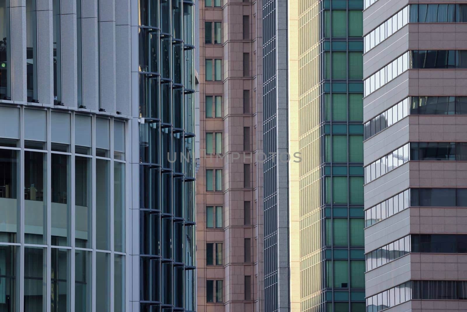 Early morning sun hits glass office buildings in financial district. High quality photo