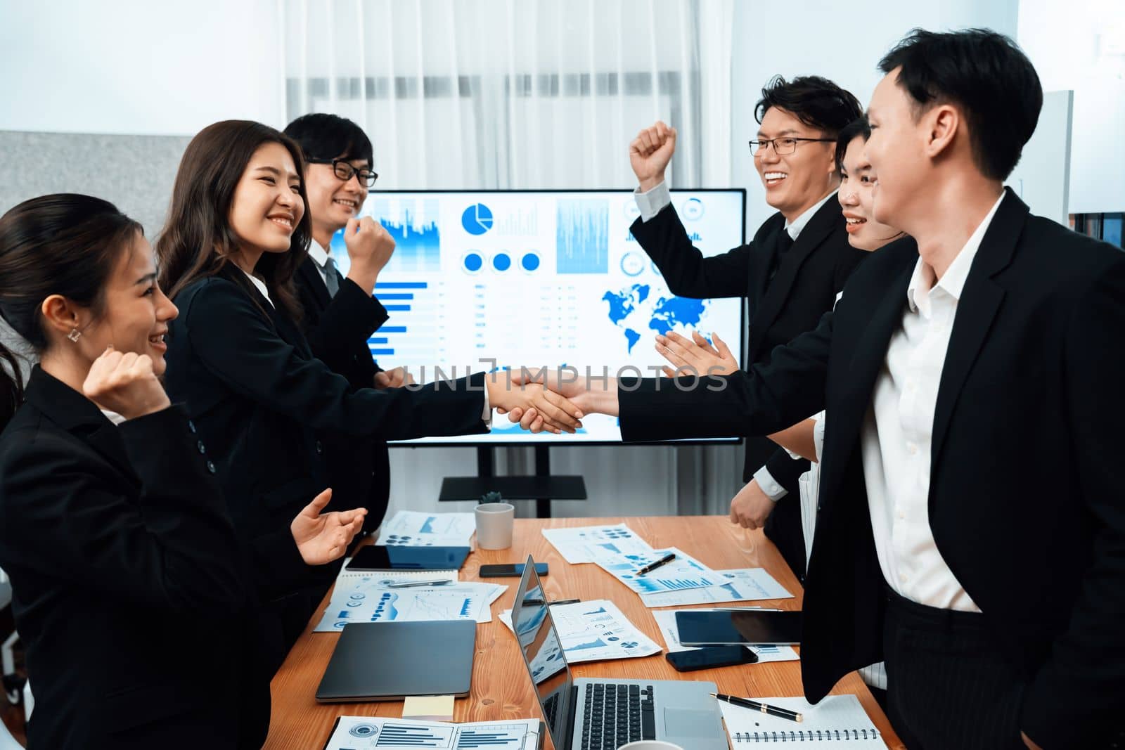 Businesspeople shake hand after successful agreement or meeting. Office worker colleague handshake with business team leader manager for strong teamwork in office to promote harmony and unity concept.