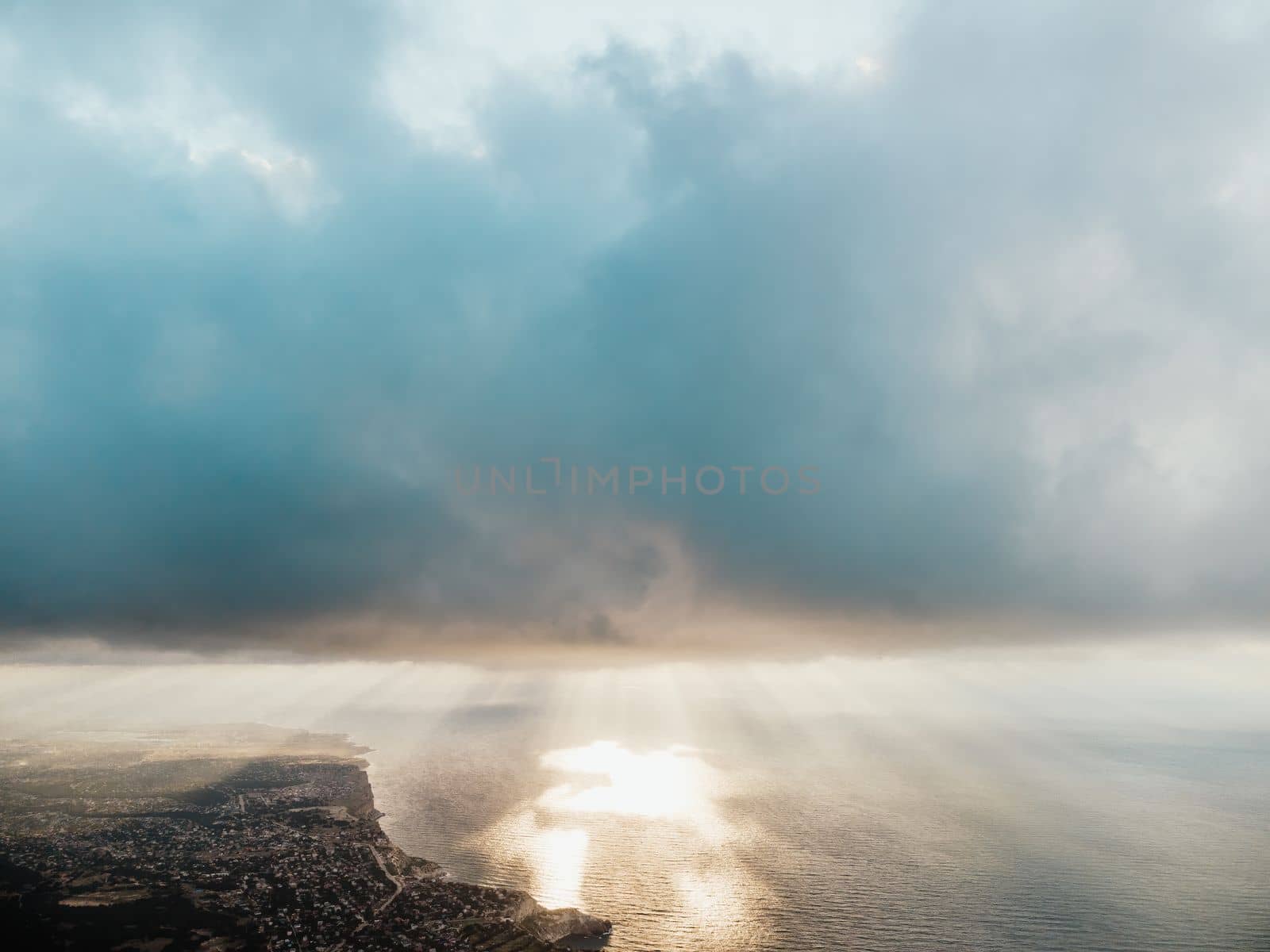 Blue sky with white clouds over calm summer panorama of the sea. Drone aerial view. Abstract aerial nature summer ocean sunset sea and sky background. Horizon. No people. Holiday and vacation concept