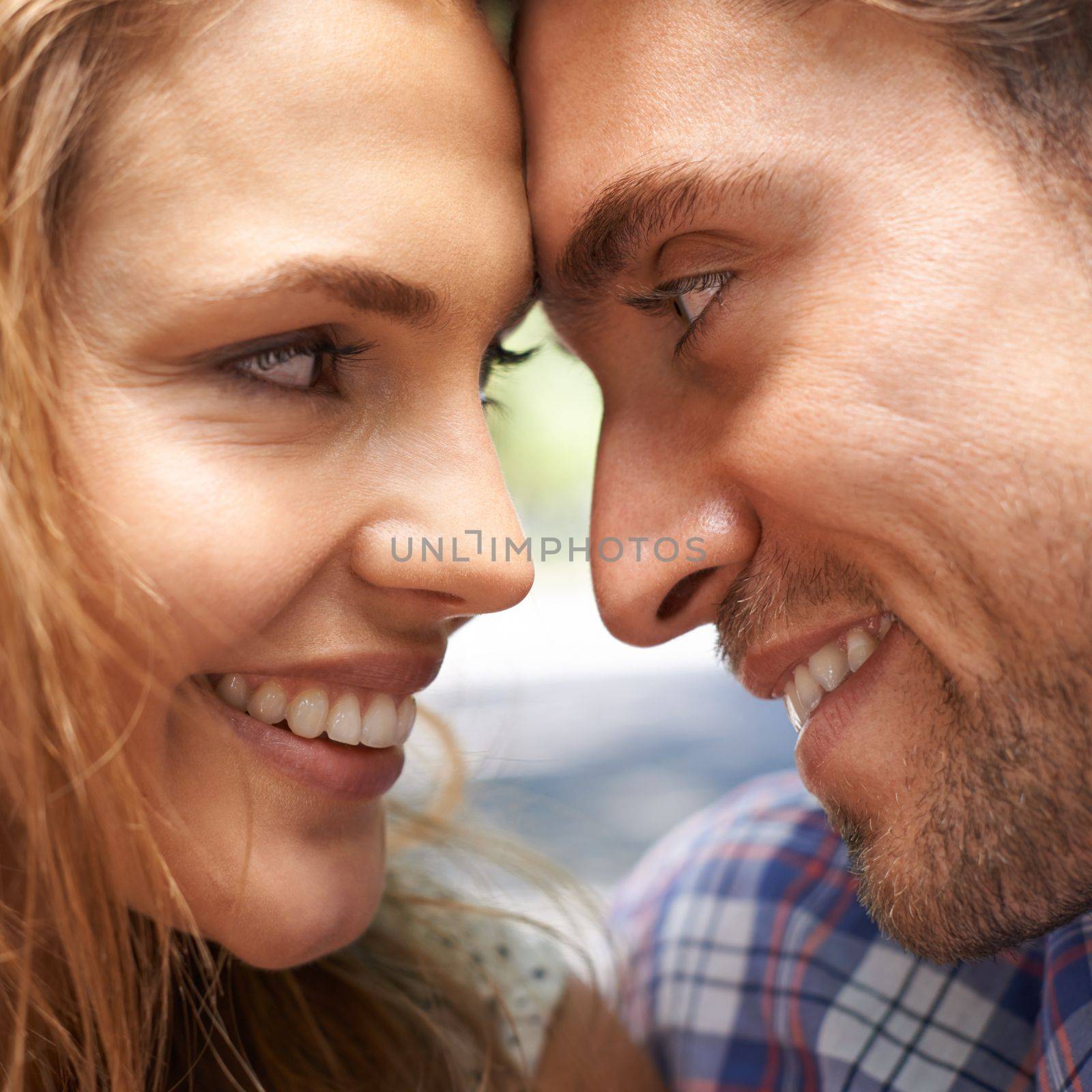 Happy couple, face or forehead touch on love date, valentines day or romance in nature, park or relax garden bonding. Zoom, man or woman touching heads in smile trust, security or thank you support.