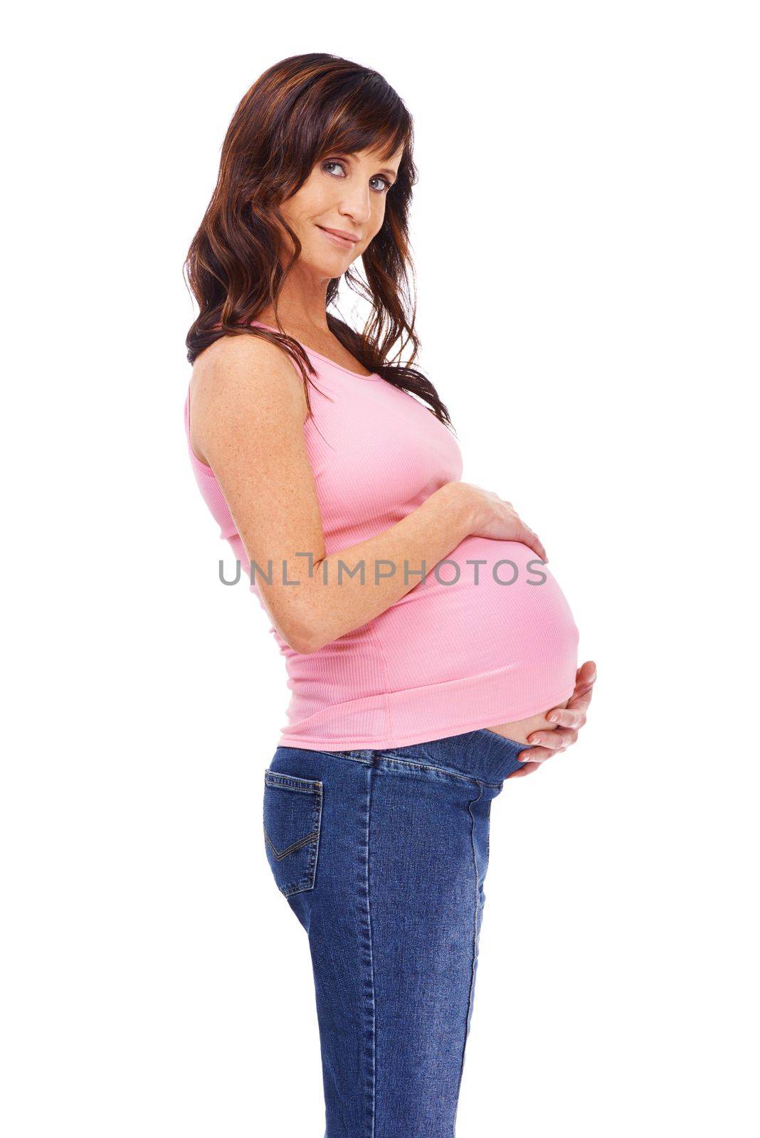 Considering her childs future. A young pregnant woman standing against a white background. by YuriArcurs