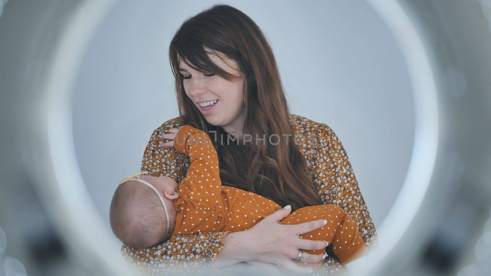 A loving mother sings for her child in a circle of light