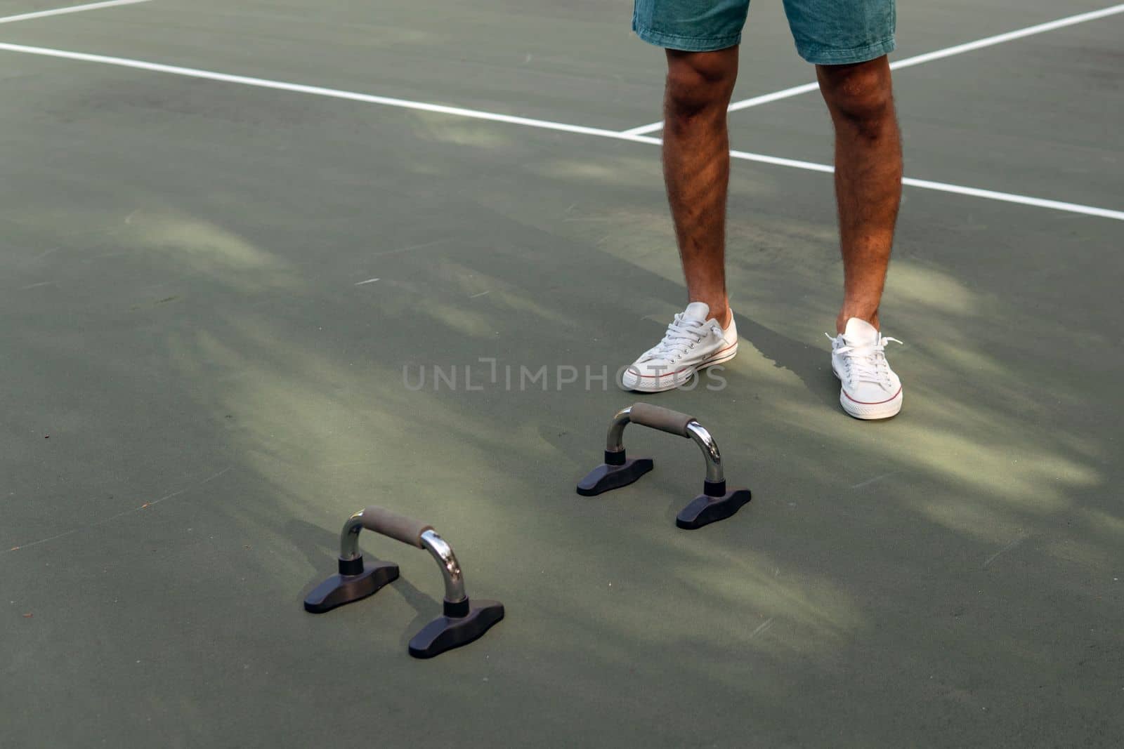 man doing push-ups on the court by Alexzhilkin