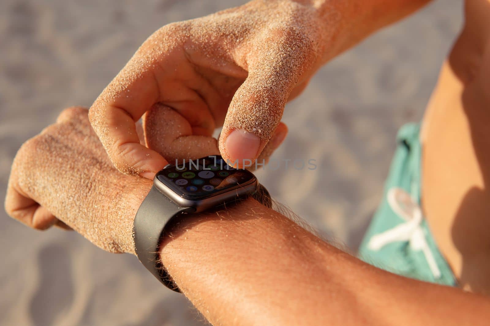 a man checks his pulse after training by Alexzhilkin