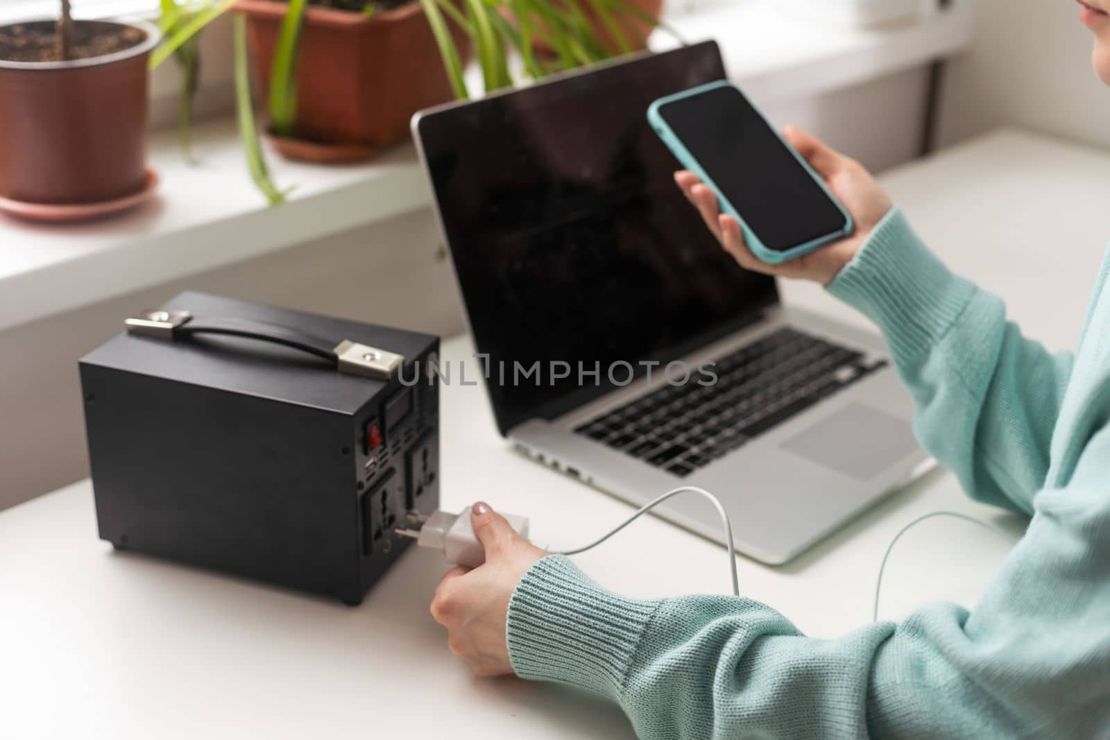 woman and portable charging station with phone