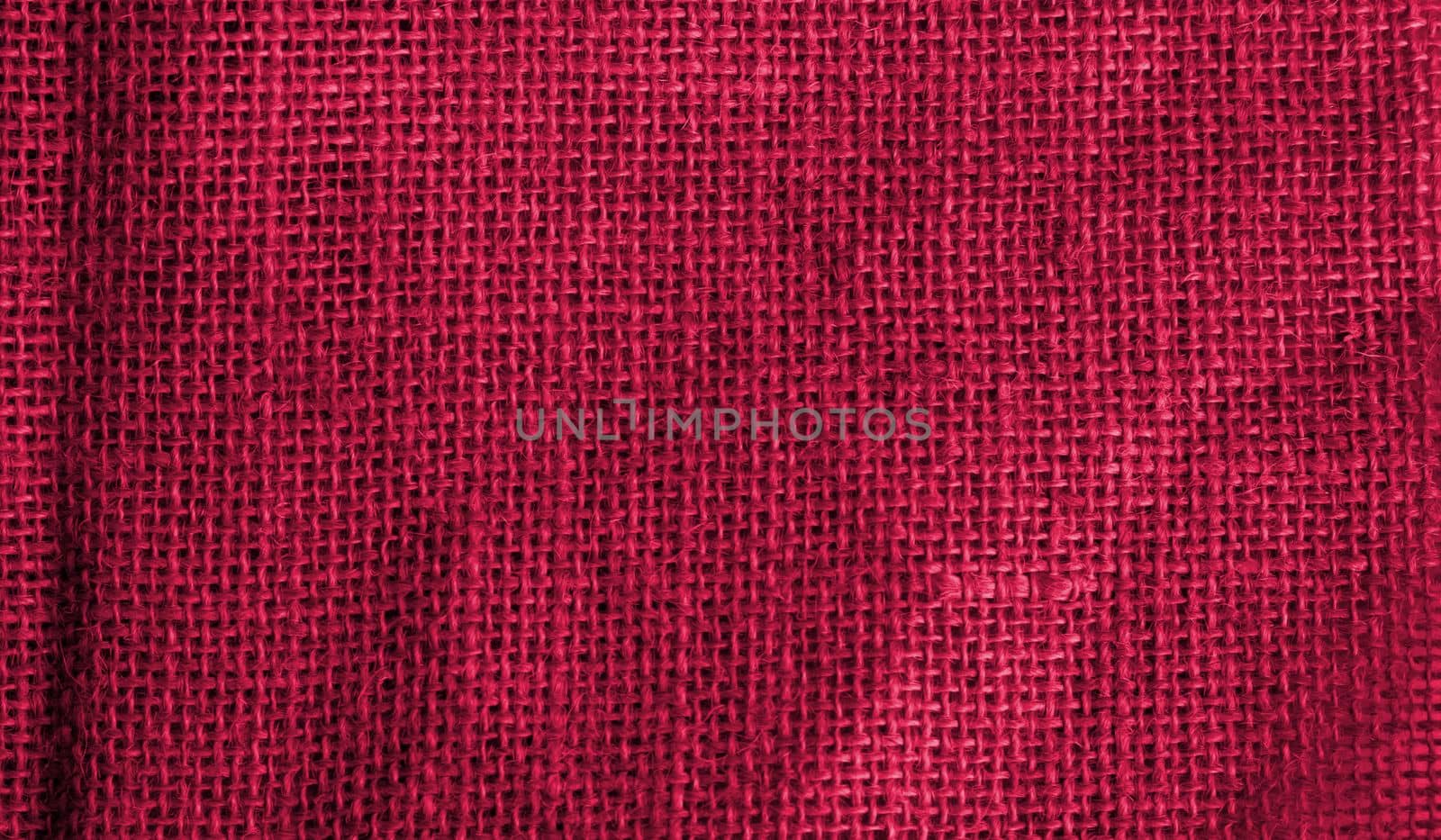 Viva Magenta burlap with a beautiful retro canvas texture as a vintage background.