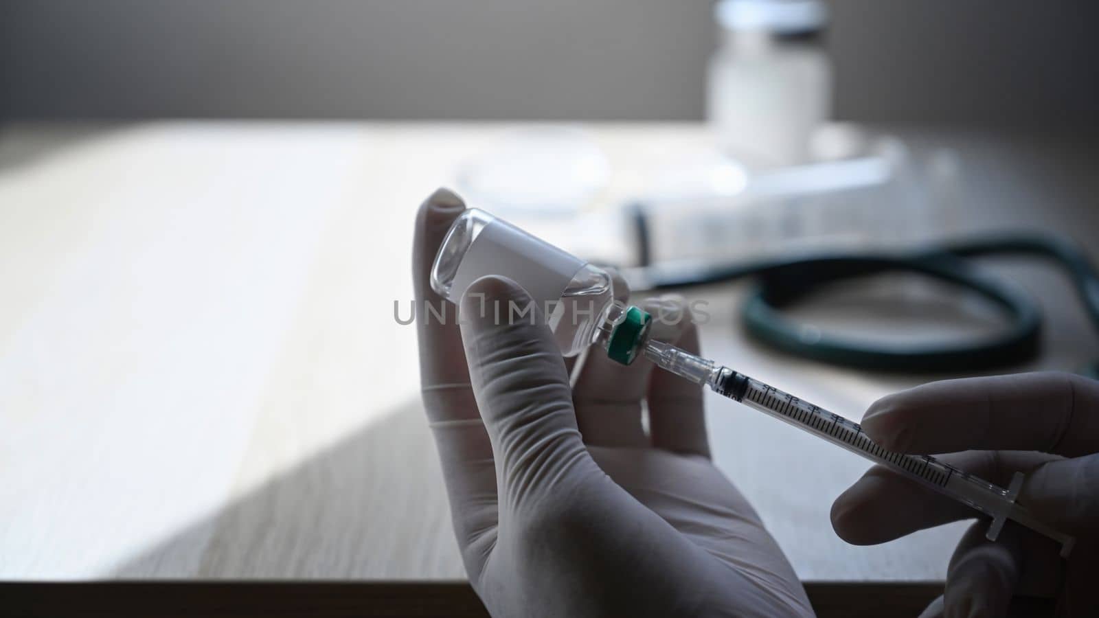 Close up doctor holding syringe and bottle of vaccine. Healthcare and Medical concept. by prathanchorruangsak
