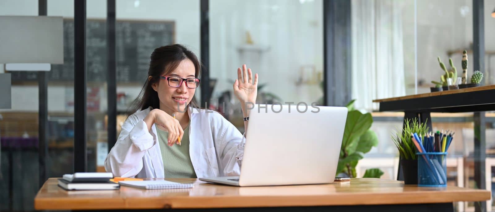 ​Asian businesswoman having video conference with business partner on laptop computer.