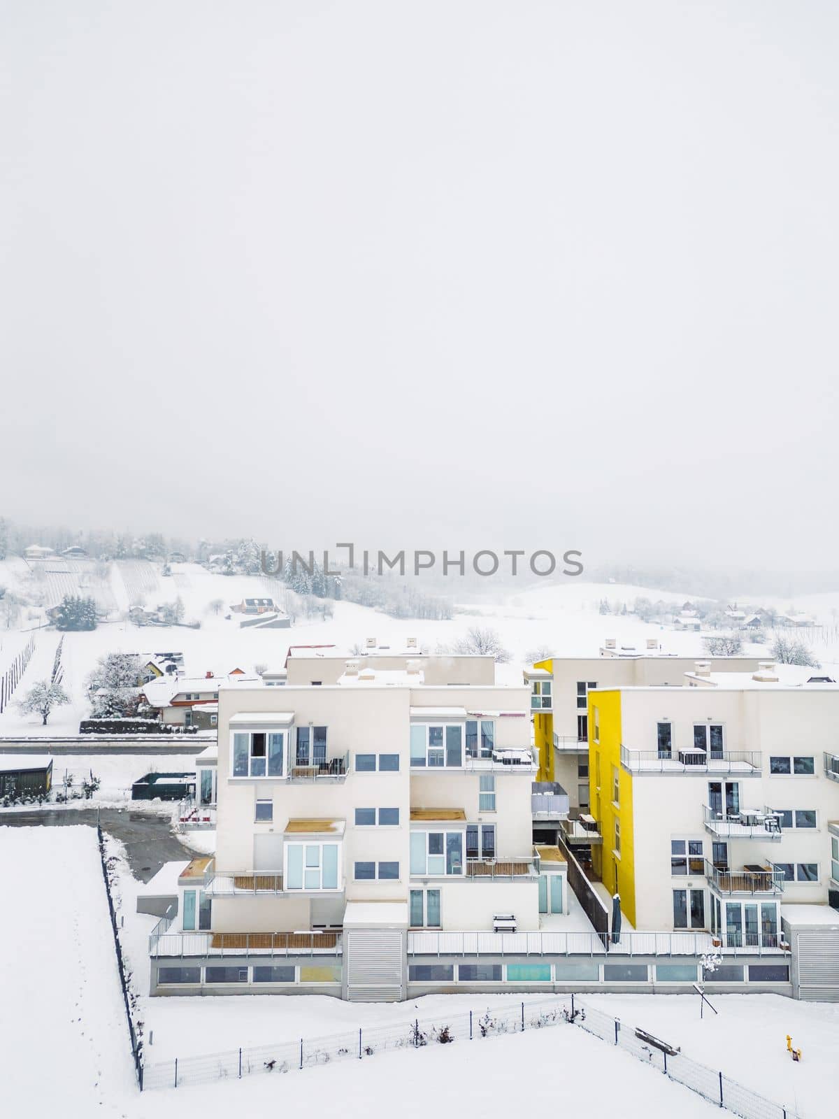 Newly build residential complex with apartments on a snowy winter day by VisualProductions
