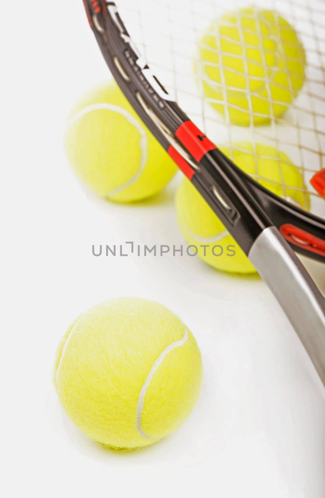 Sport tennis. Yellow tennis balls and tennis racket isolated on a white background by aprilphoto