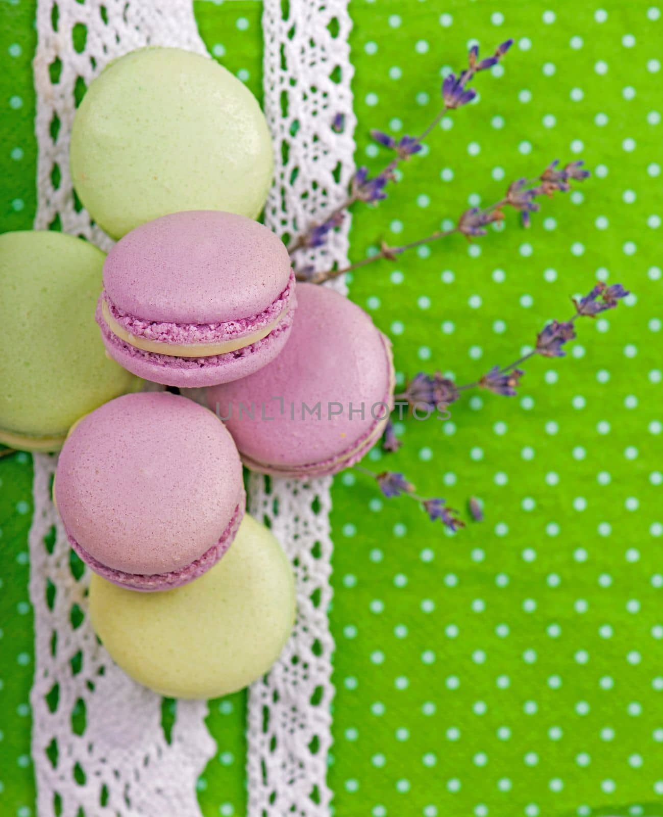 Sweet macaroons on a green napkin, vintage color tone by aprilphoto