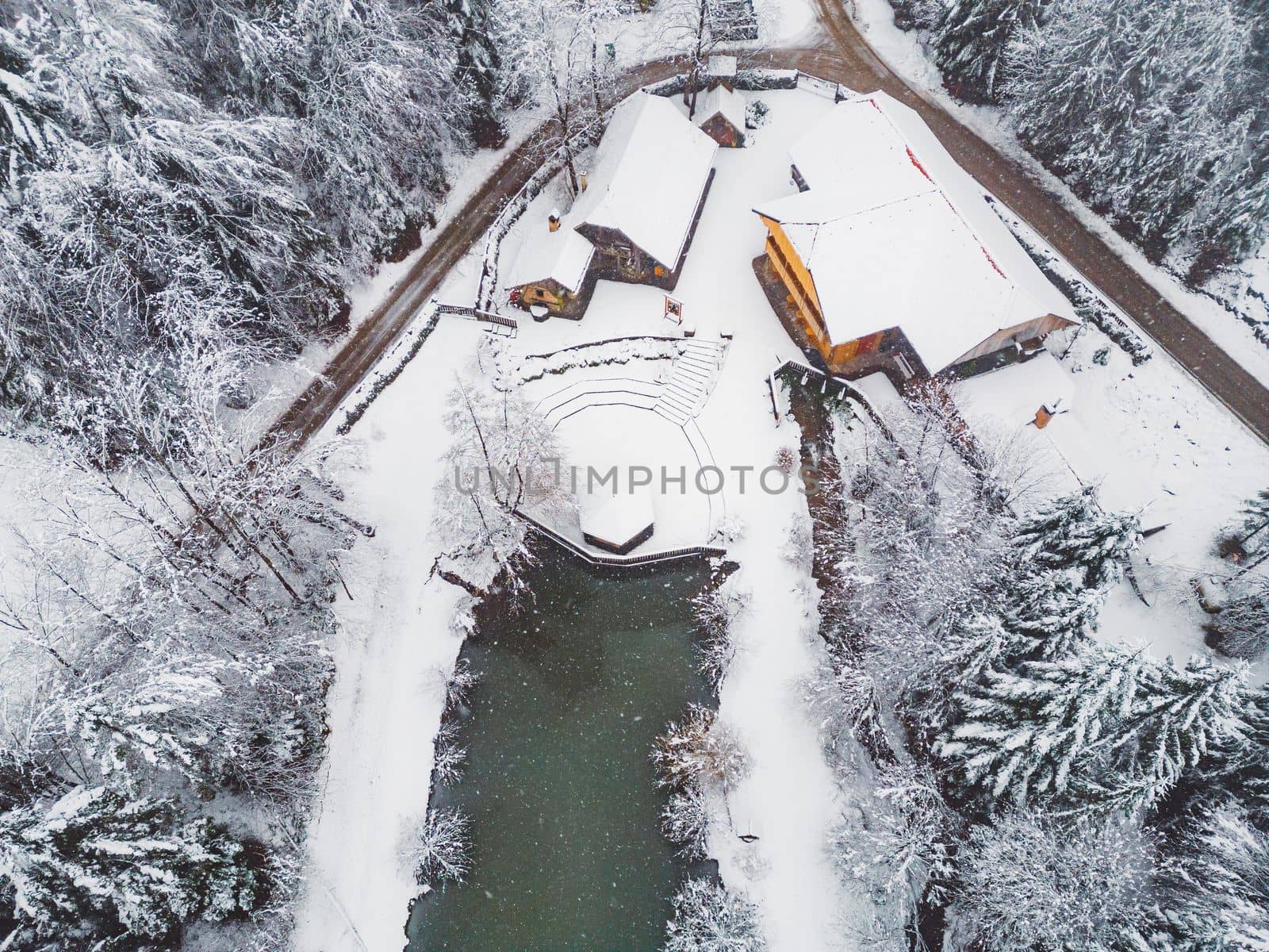 Beautiful winter nature, white snow covering the land, trees covered in snow, branches cracking under the weight. Frozen winter lake, beautiful winter scenery.