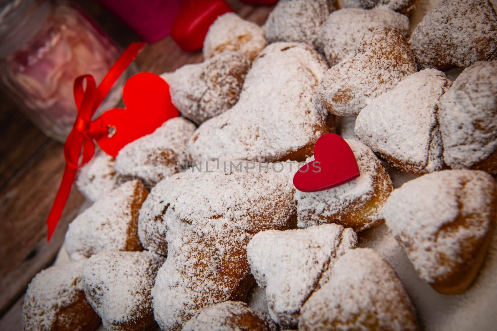 Recipe for soft heart-shaped doughnuts for Valentine's Day. High quality photo