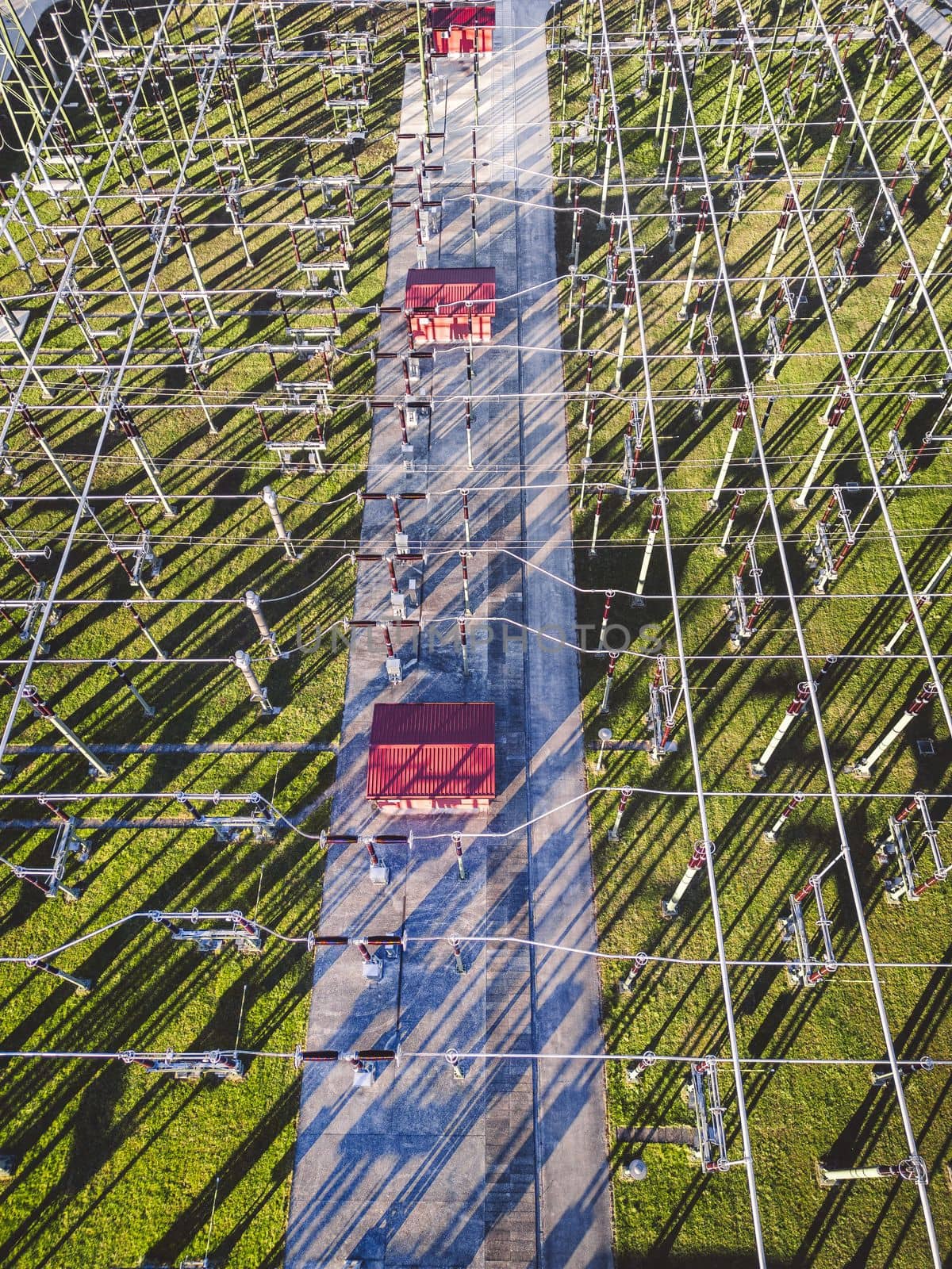 Top down view of electrical wires running around at the electrical substation by VisualProductions