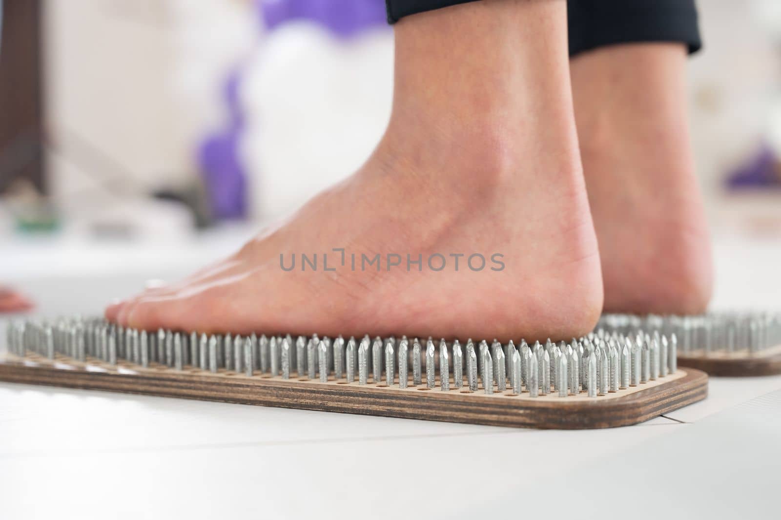 Close-up of female feet on sadhu boards