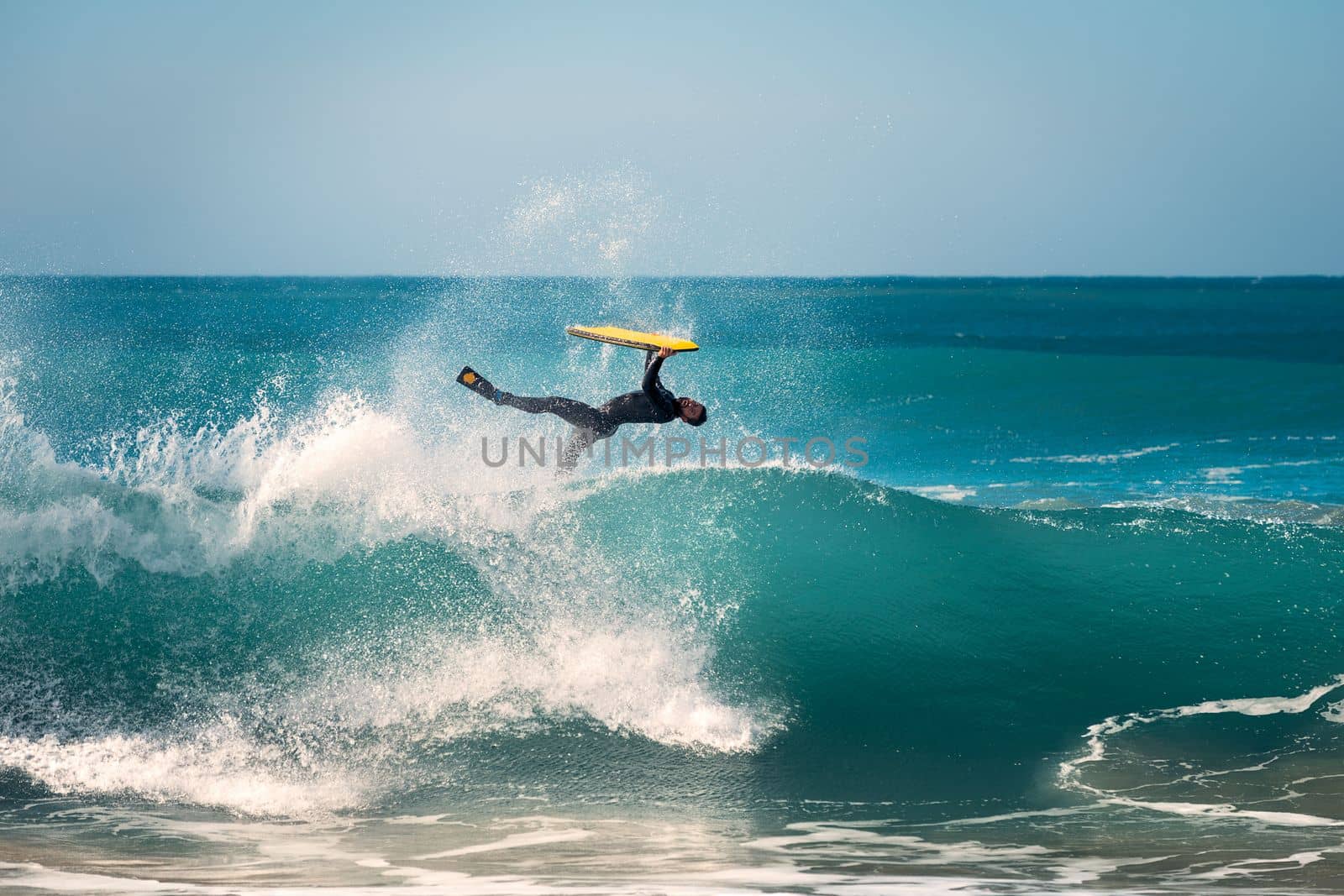 surfer doing an invert jump with his bodyboard by raulmelldo
