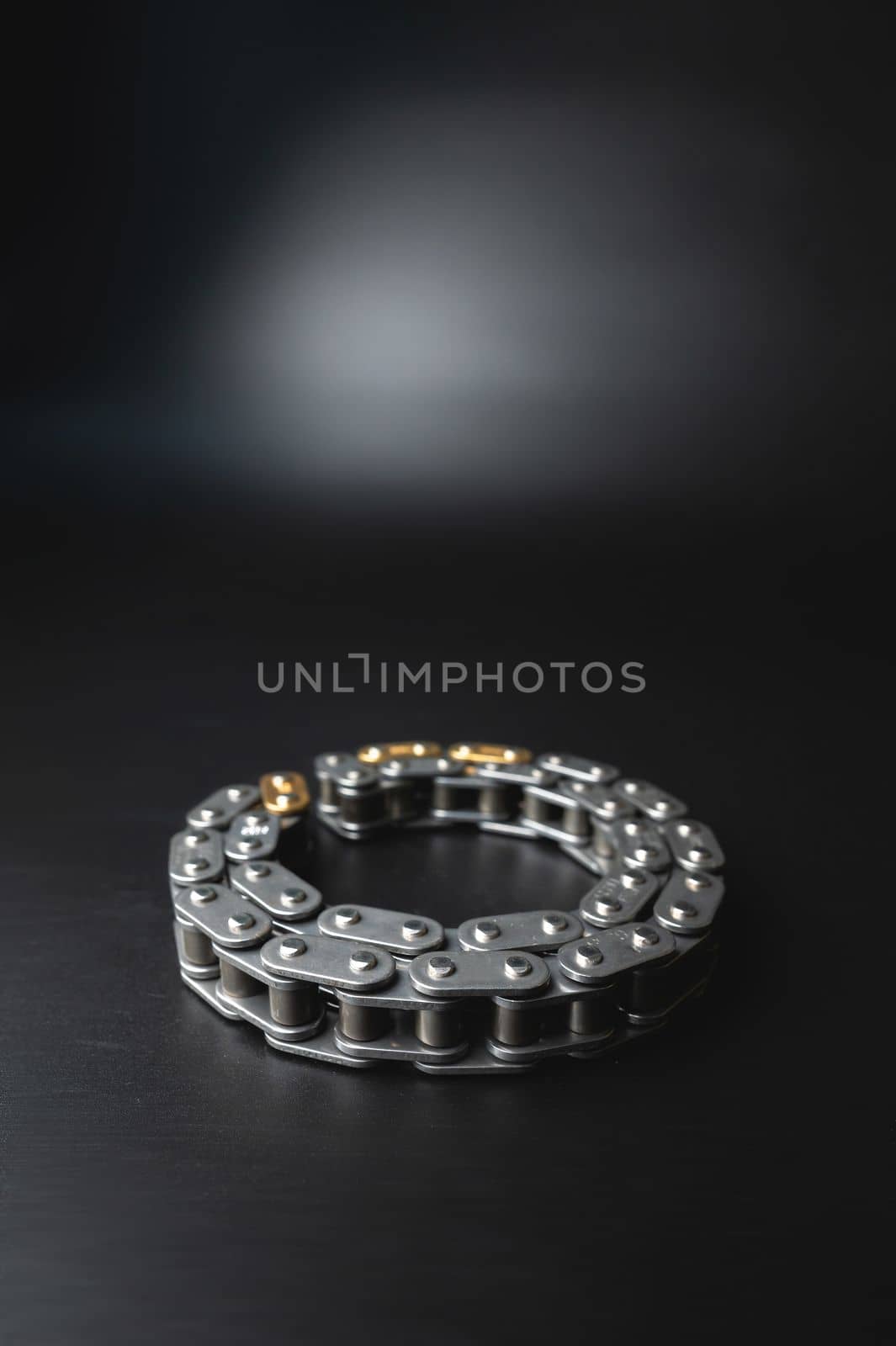 New timing chain on a black background close-up in selective focus by yanik88