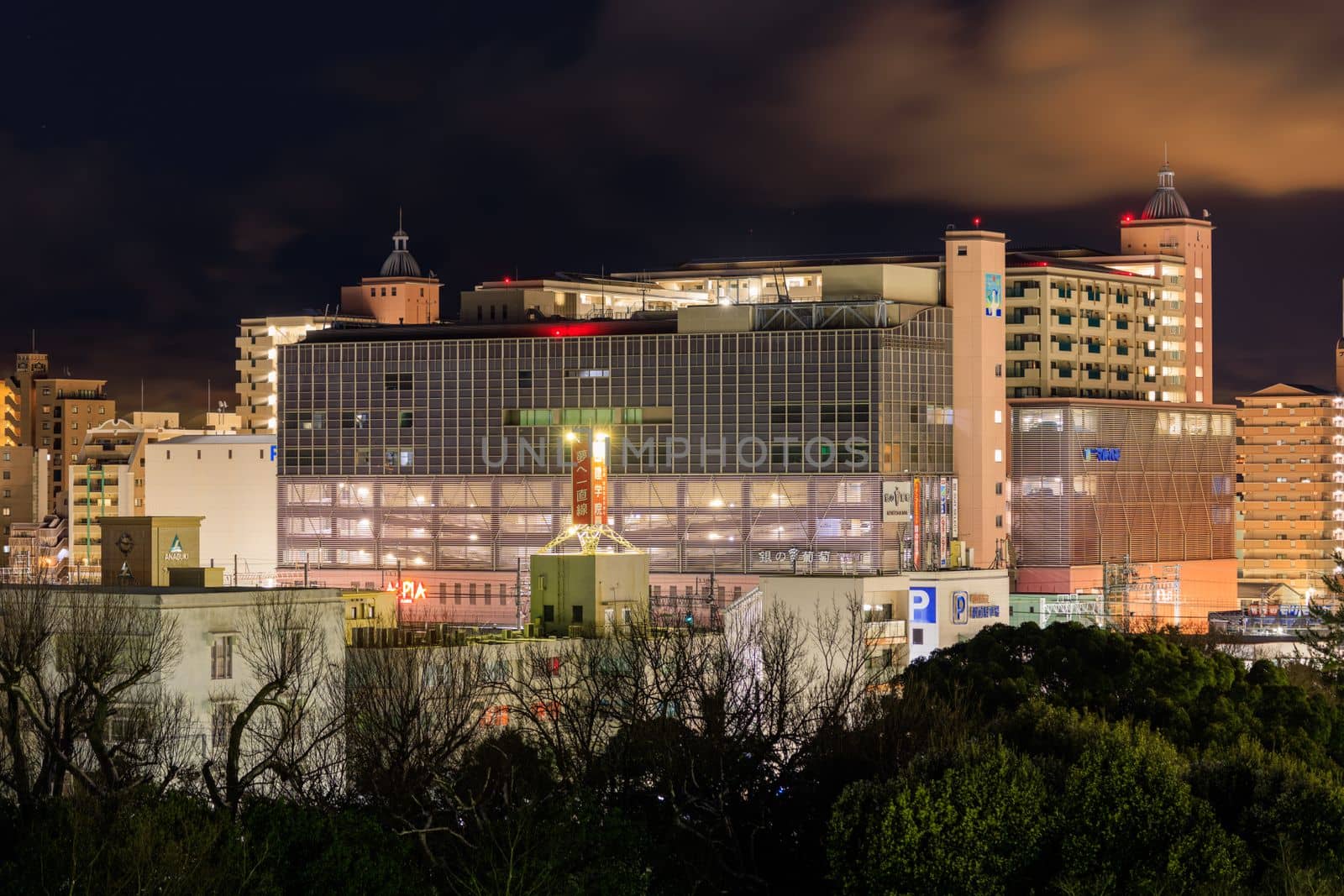 Akashi, Japan - January 25, 2023: Large shopping mall and apartment buildings in city center at night by Osaze