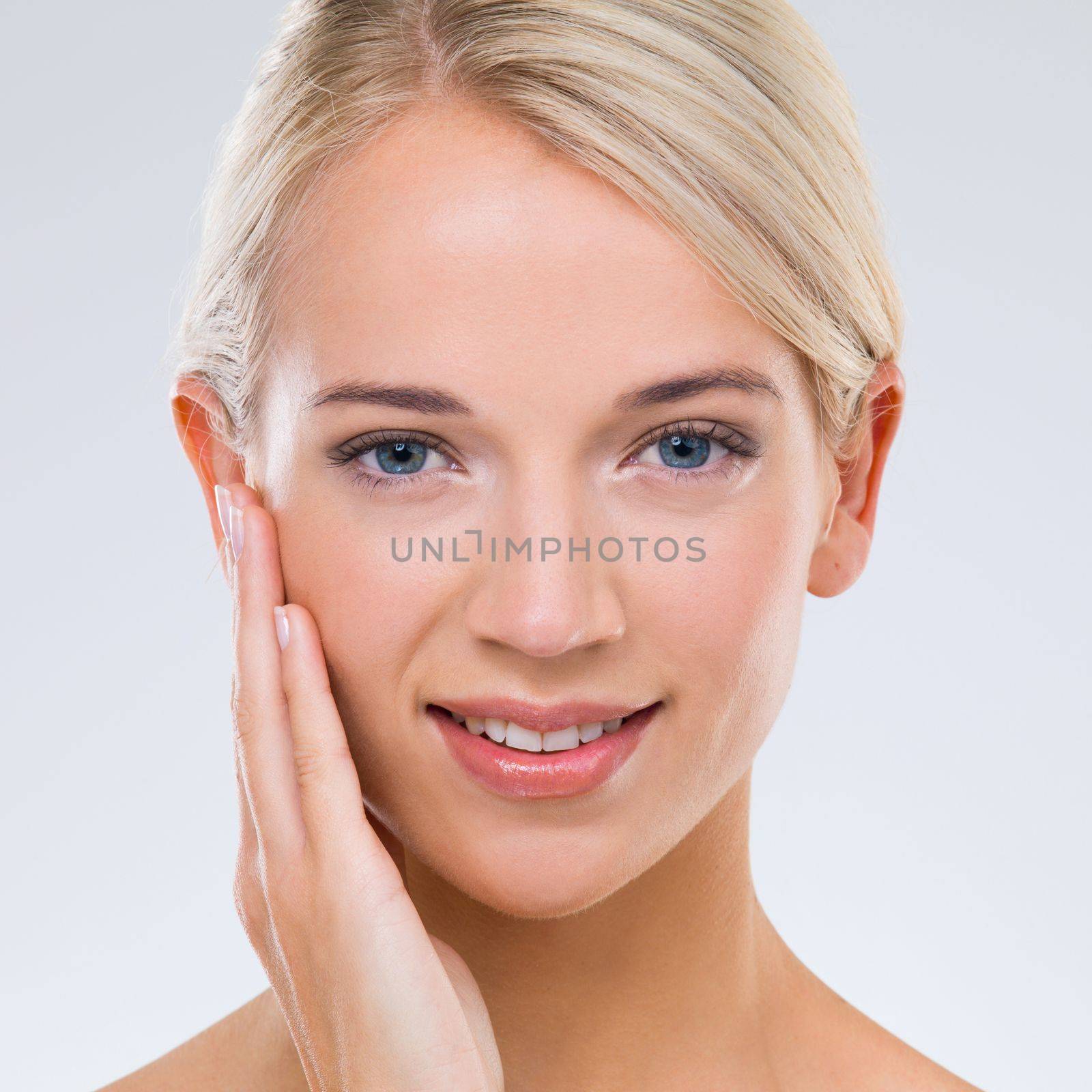 Fresh-faced beauty Got it. Portrait of a beautiful blonde touching her face with her hand