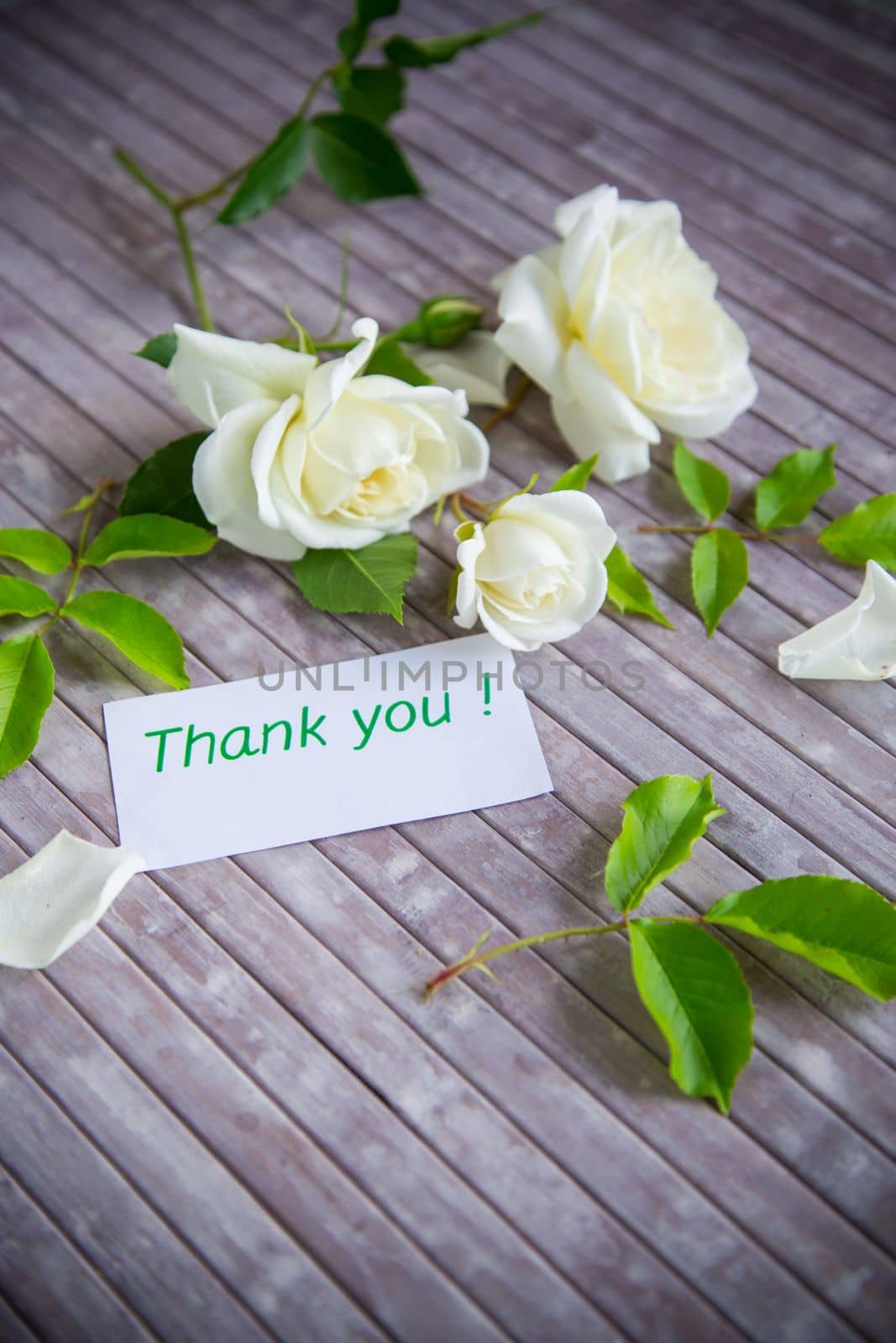 small bouquet of beautiful white summer roses, on a wooden table