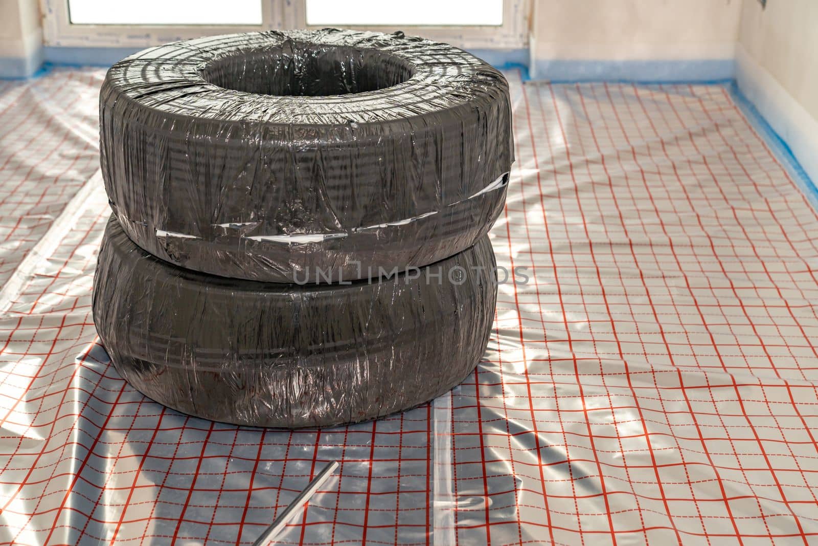 roll with pipe for underfloor heating in a new building. High quality photo