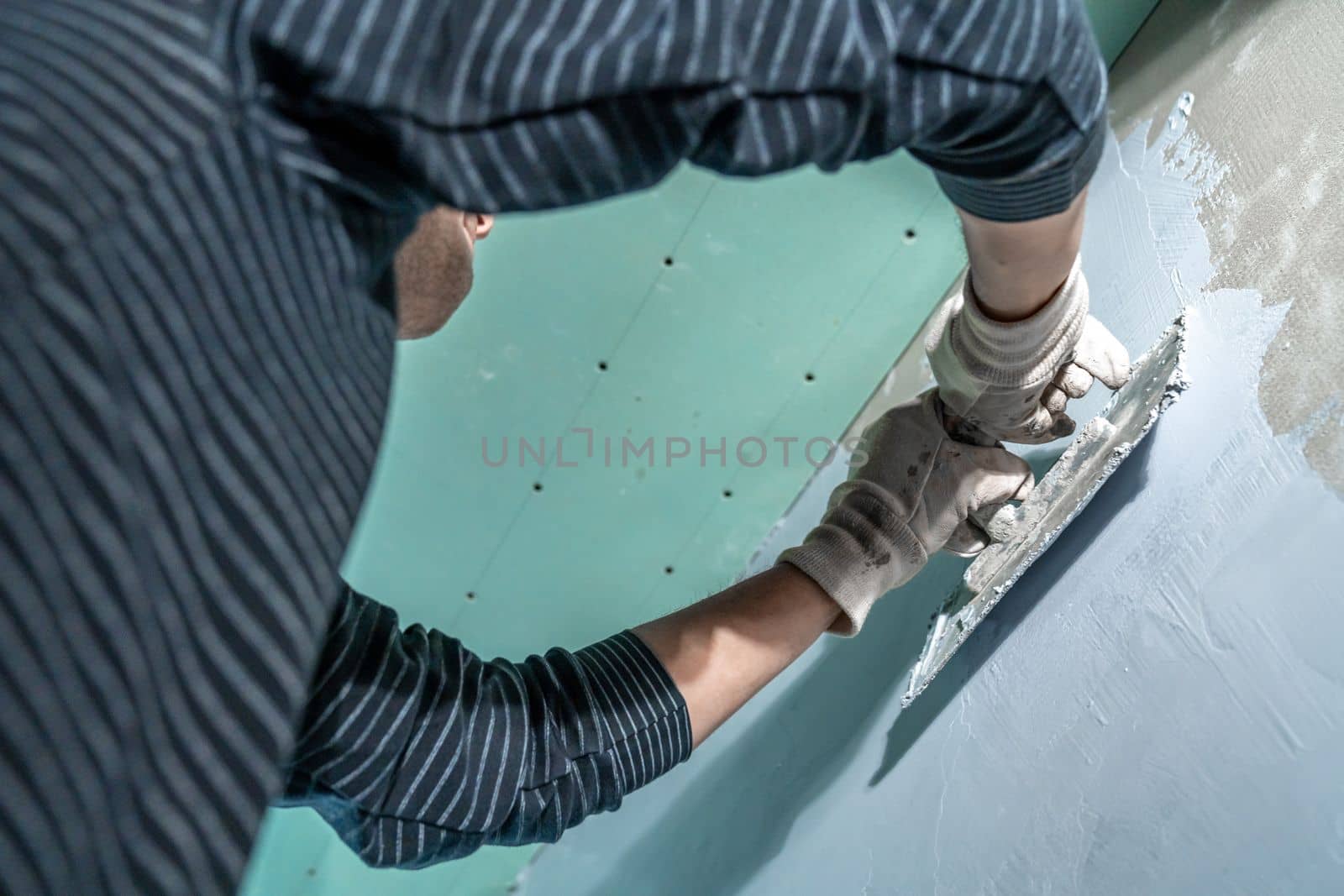 insulation of a concrete wall against moisture with the use of a trowel. High quality photo