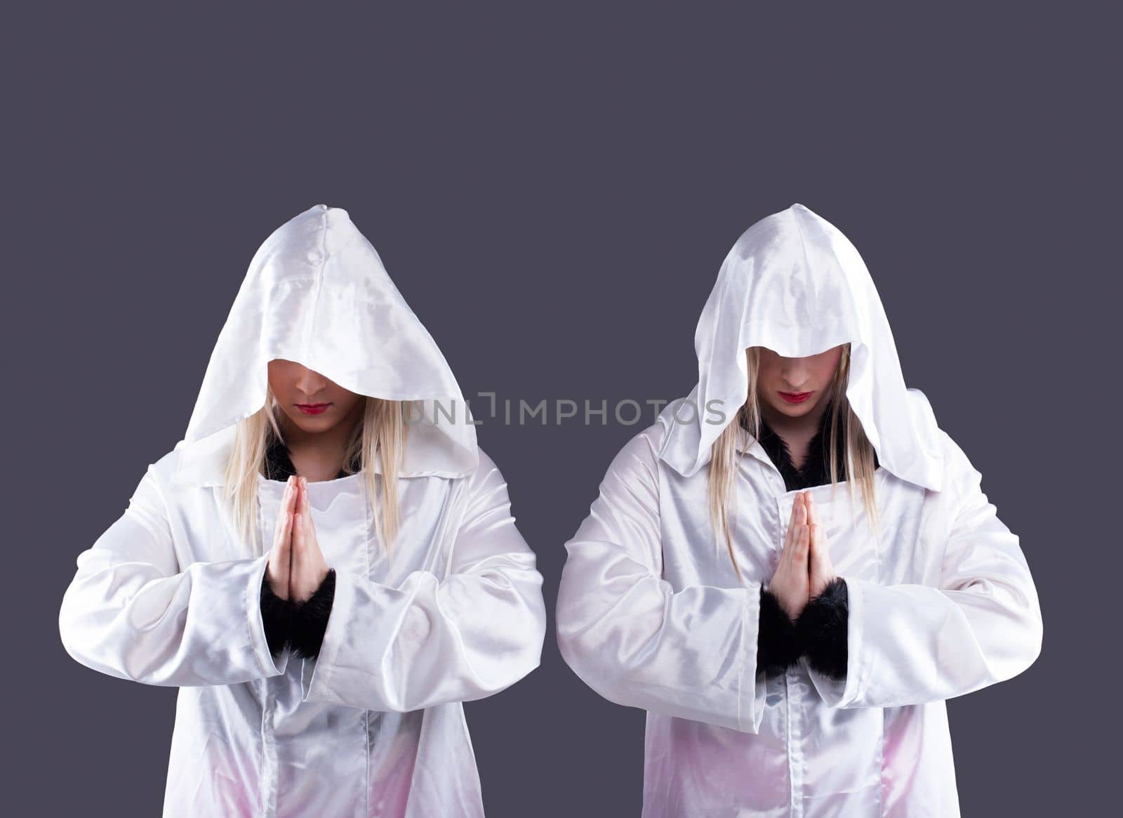 Studio portrait of two transvestites in white cloaks