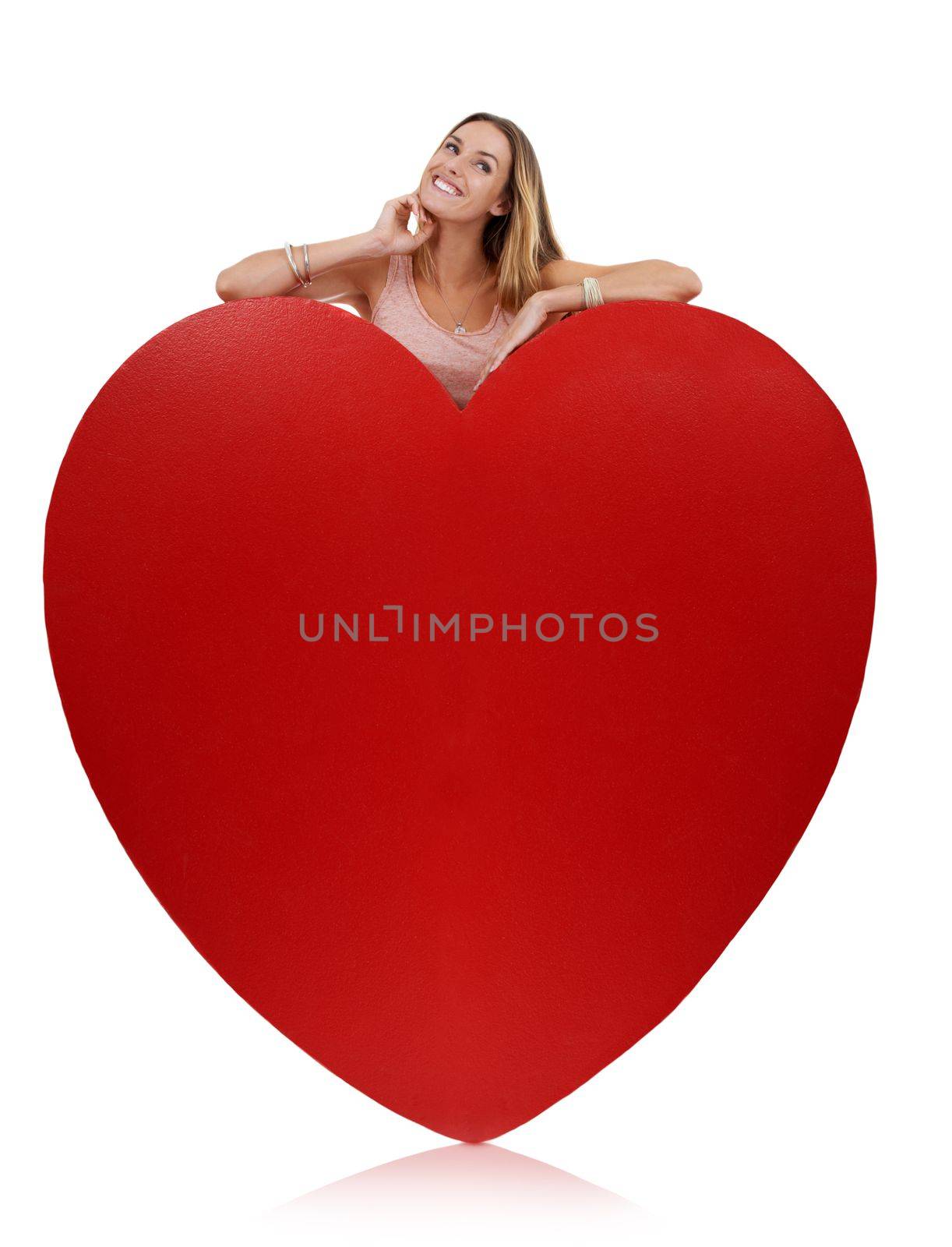 Heart, in love and woman happy with freedom and funny excited feeling behind sign. Model, white background and comic young person with happiness, joy and smile for romance and beauty isolated by YuriArcurs