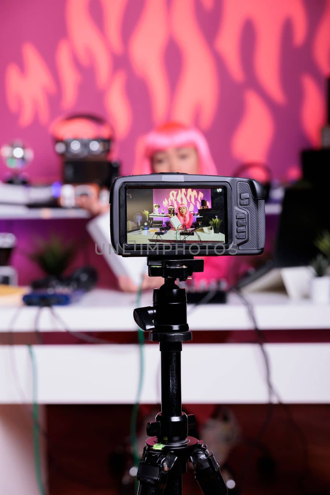 Content creator filming white box review in recording studio talking with subscribers using professional vlogging camera. Asian influencer talking with subscribers during live streaming