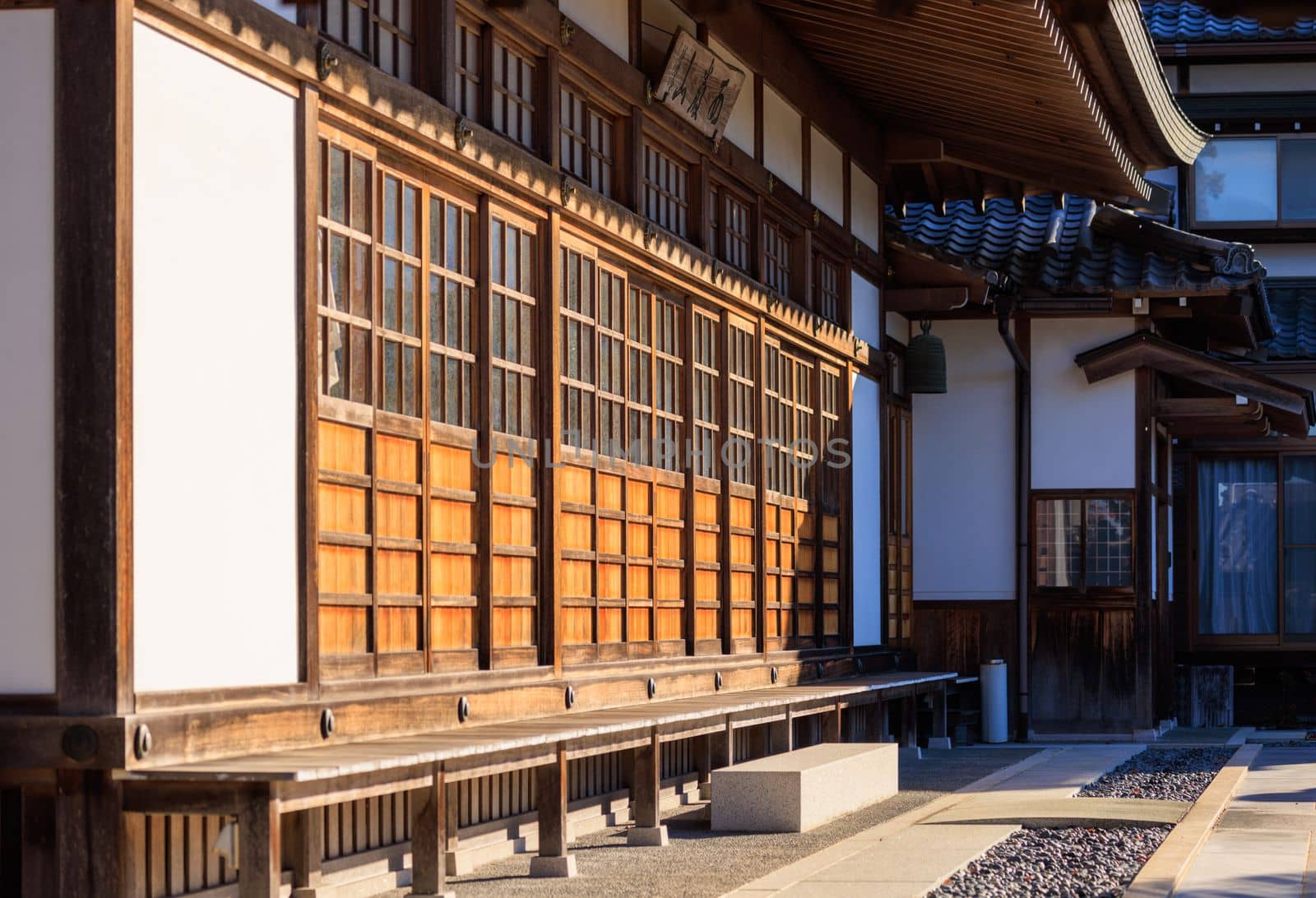 Morning sun on traditional sliding wooden doors at Japanese temple by Osaze