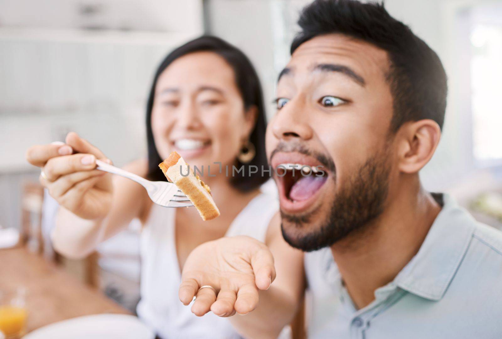 In family life, love is the oil that eases friction. a young couple have some lunch with the family at home