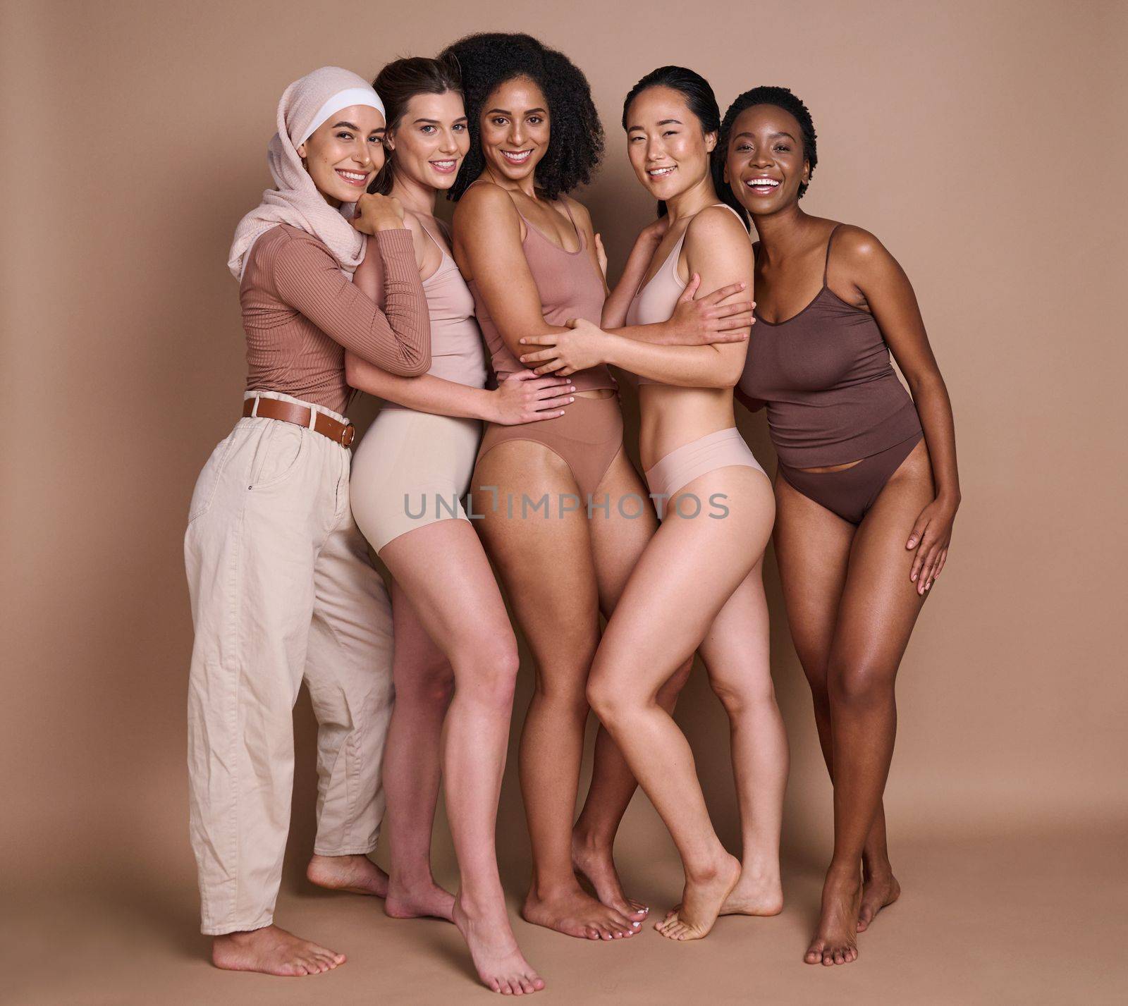 Beauty skincare, diversity and group of women in studio on a brown background. Underwear, makeup cosmetics and portrait of different female models posing for self love, empowerment or body positivity.