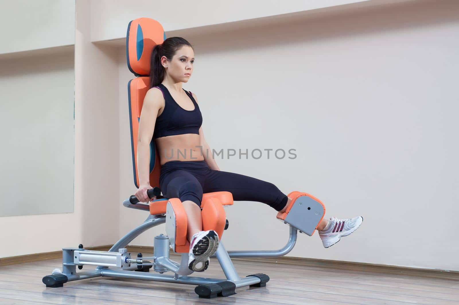 Full length portrait of athletic young woman in gym
