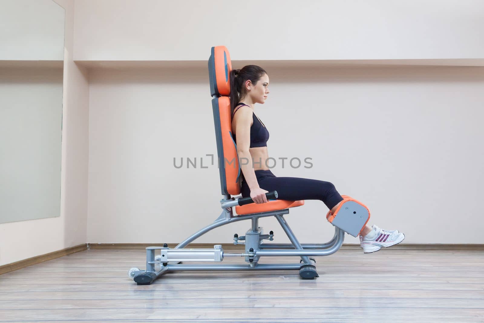 Full length portrait of pretty young woman in gym