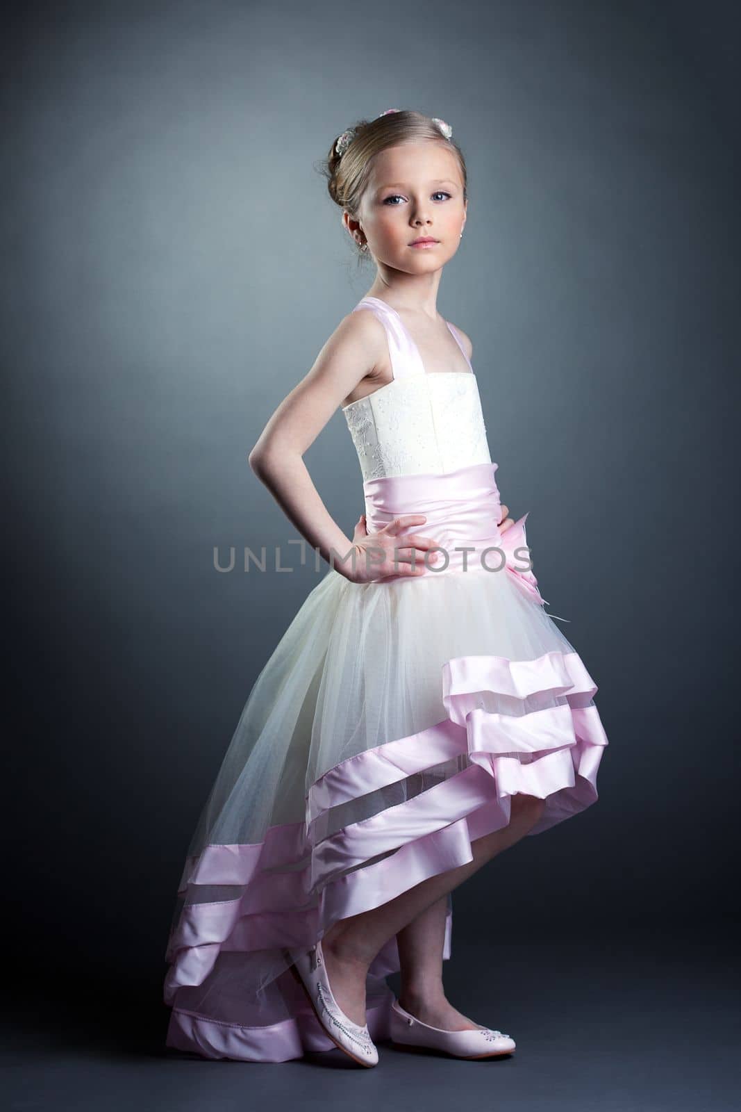 Studio portrait of pretty little girl in dress