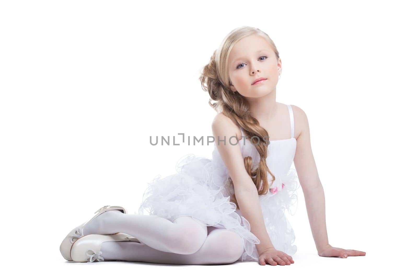 Portrait of sitting pretty girl in white dress, isolated on white