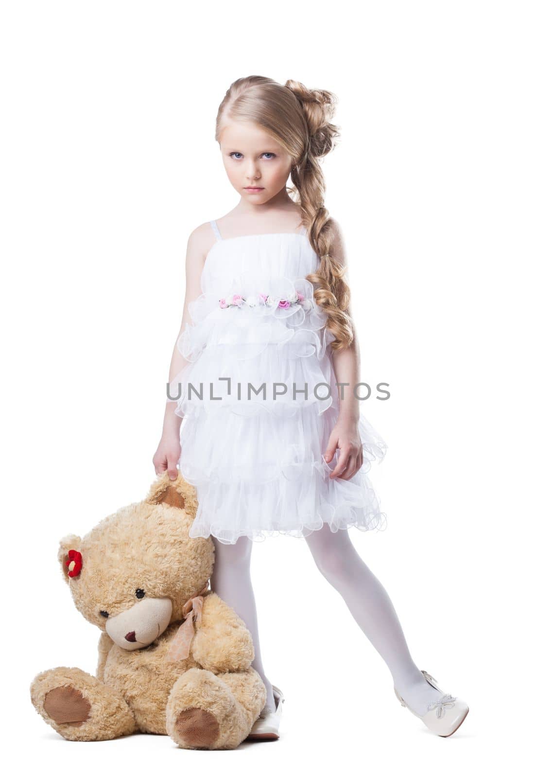 Full length portrait of sad little girl with soft toy. Isolated on white