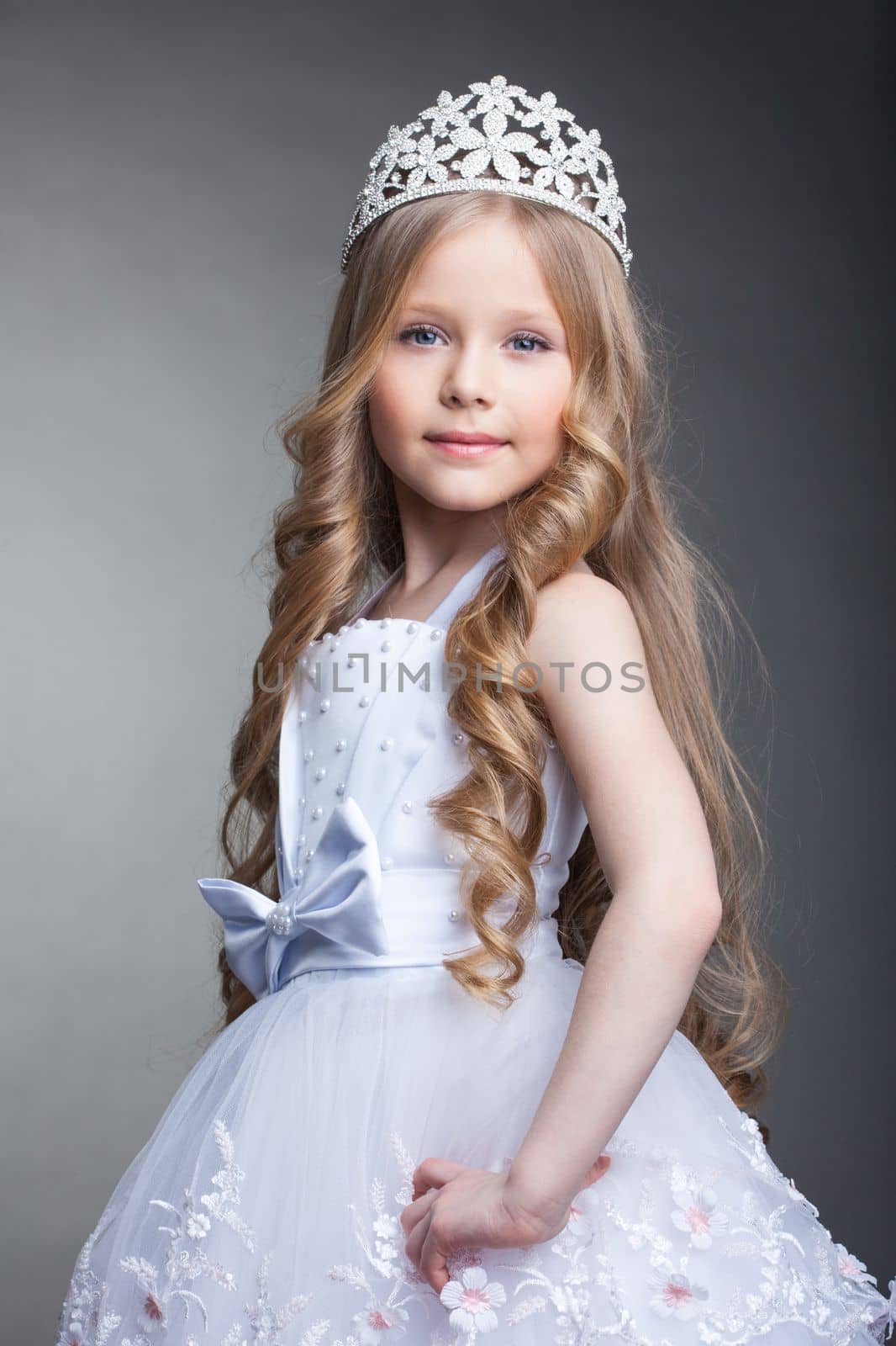 Studio portrait of pretty little girl in tiara